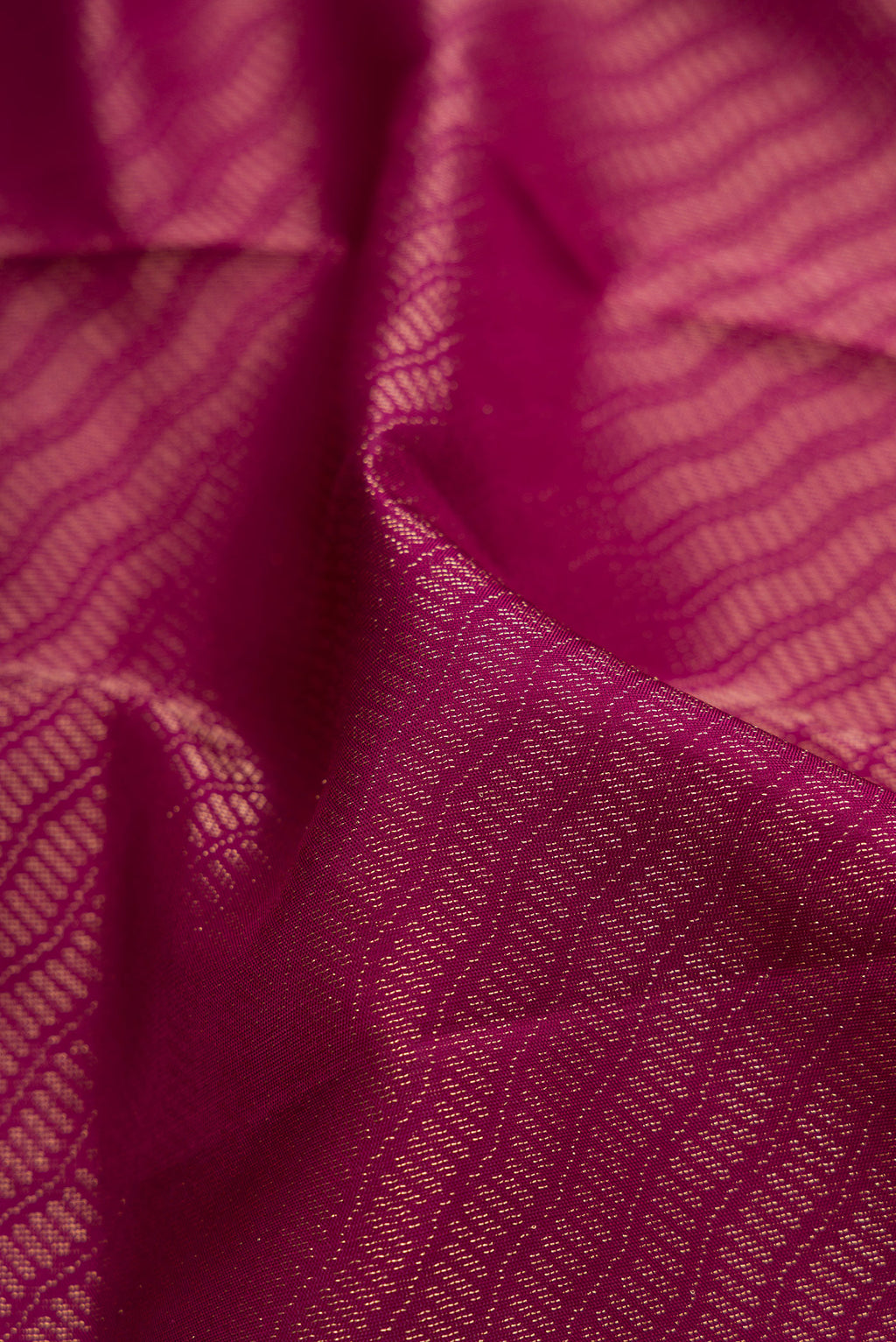 Close up of Magenta Soft Silk Saree with Zari Brocade on the body and Fancy Border.  displaying folds