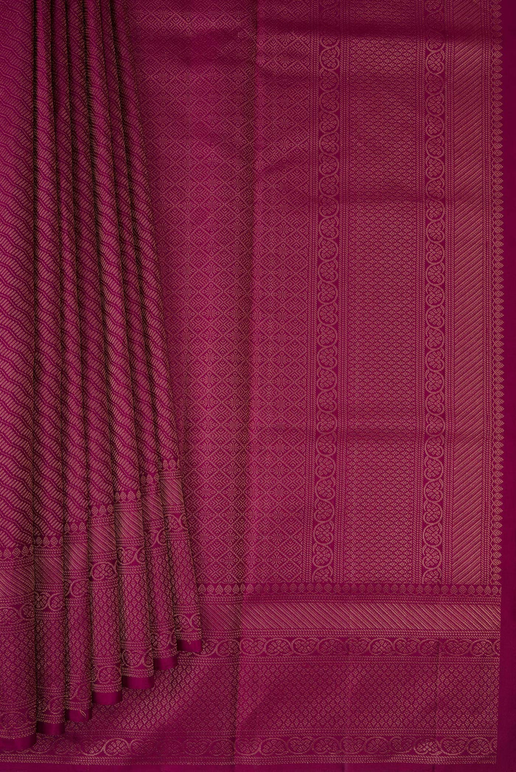 Pleats and pallu of Magenta Soft Silk Saree with Zari Brocade on the body and Fancy Border. 