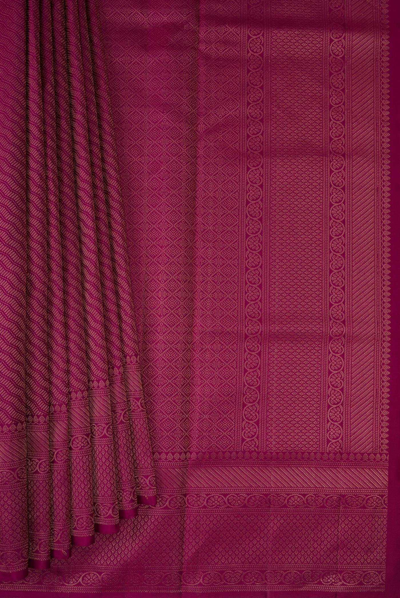Pleats and pallu of Magenta Soft Silk Saree with Zari Brocade on the body and Fancy Border. 