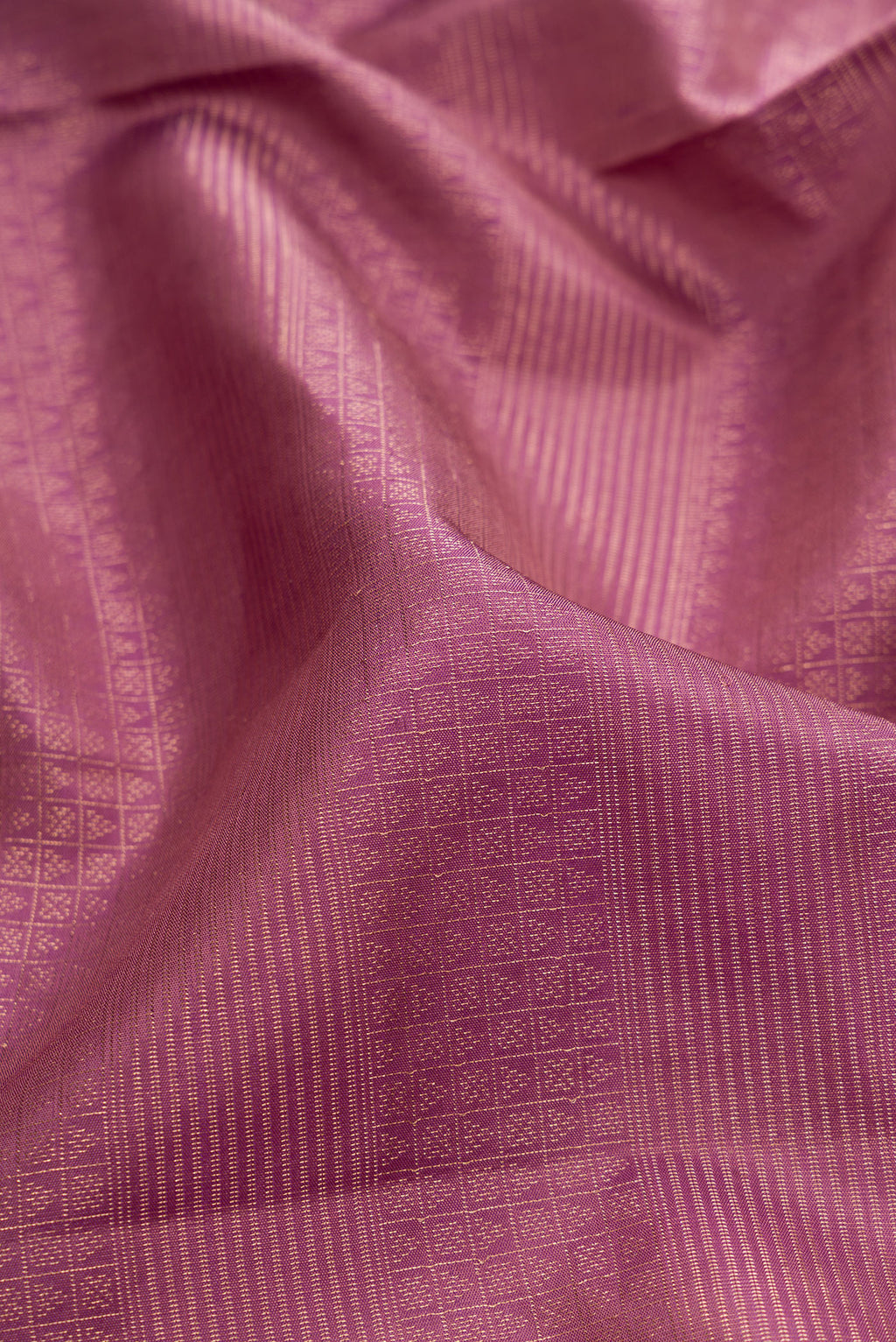 Close up of Purple Soft Silk Saree with Zari Brocade on the body and Fancy Border.  displaying folds