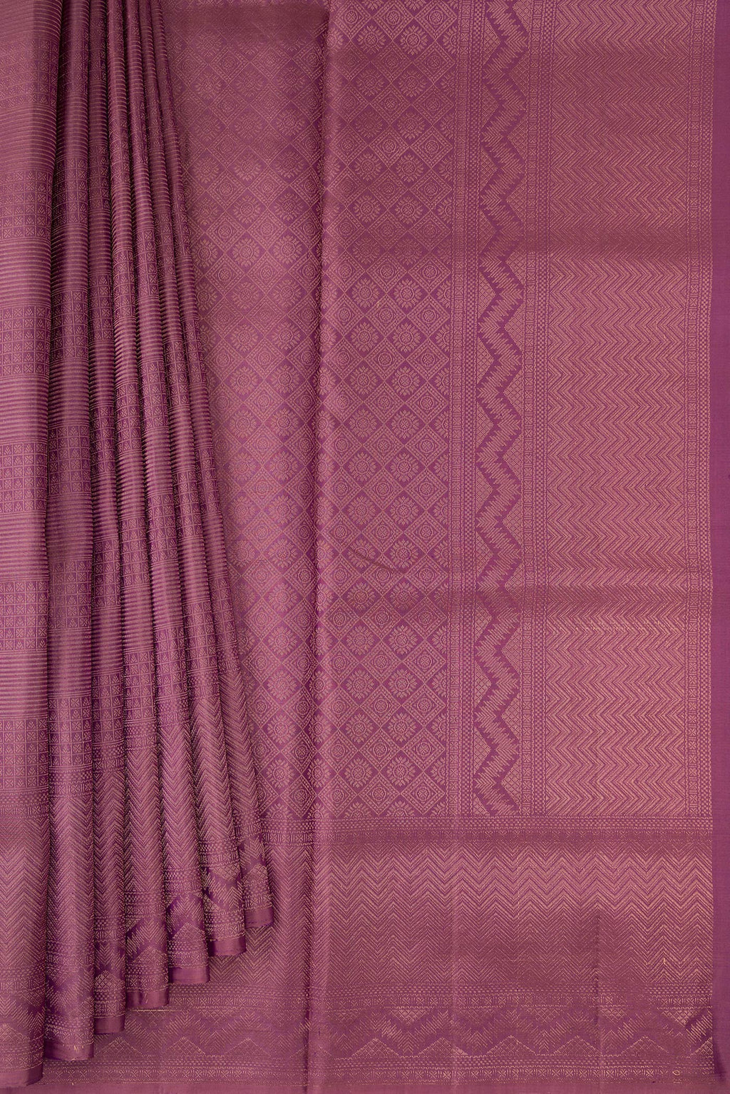 Pleats and pallu of Purple Soft Silk Saree with Zari Brocade on the body and Fancy Border. 