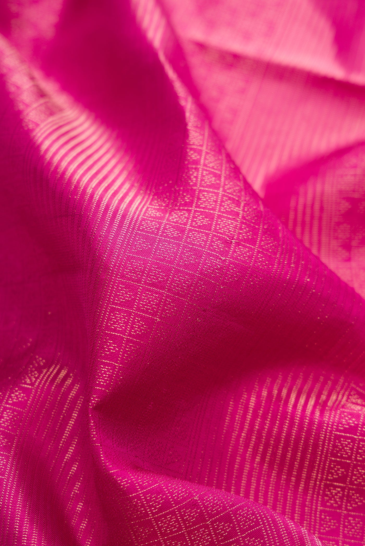 Close up of Magenta Soft Silk Saree with Zari Brocade on the body and Fancy Border.  displaying folds