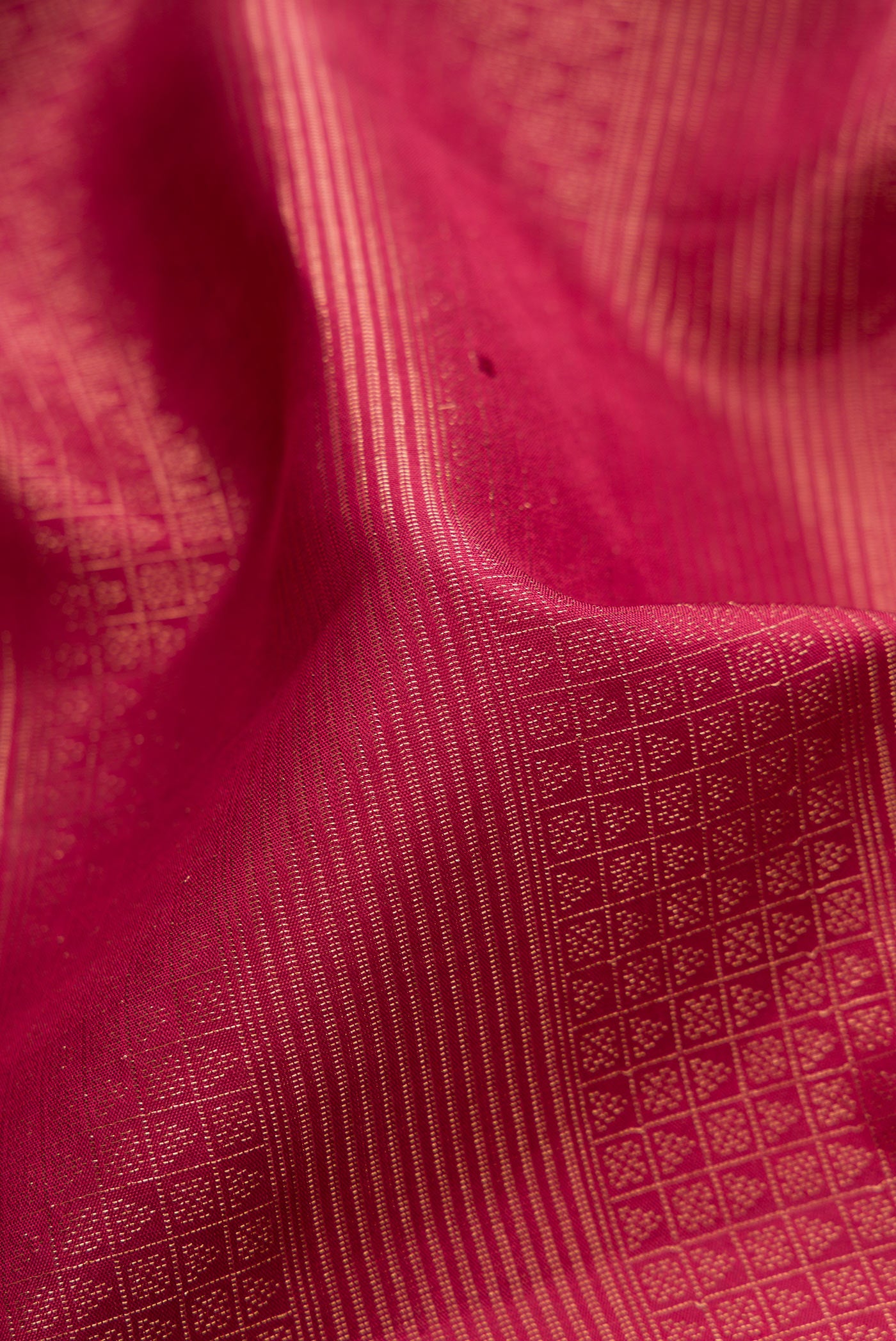 Close up of Maroon Soft Silk Saree with Zari Brocade on the body and Fancy Border.  displaying folds