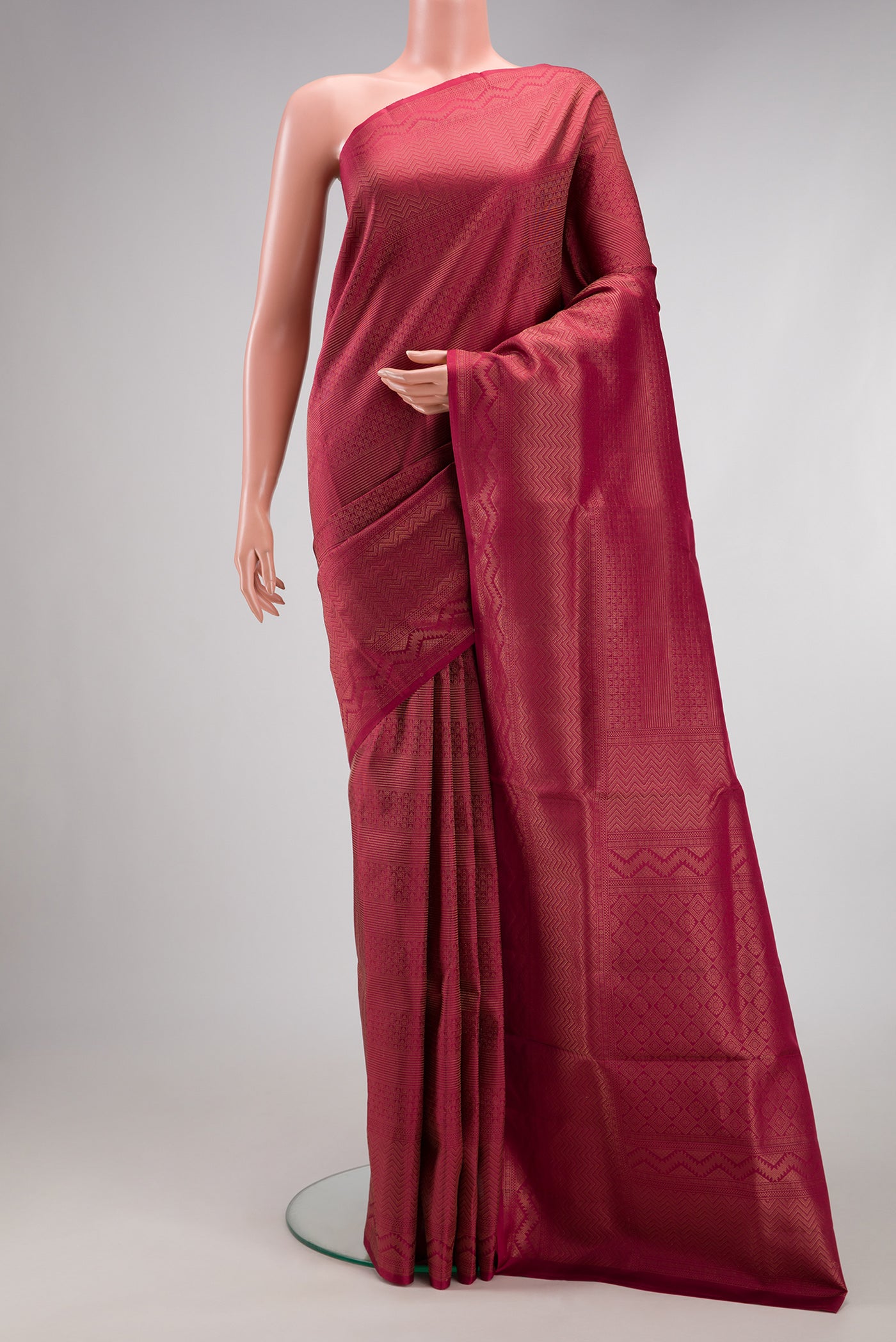 Maroon Soft Silk Saree with Zari Brocade on the body and Fancy Border.  displayed on a mannequin