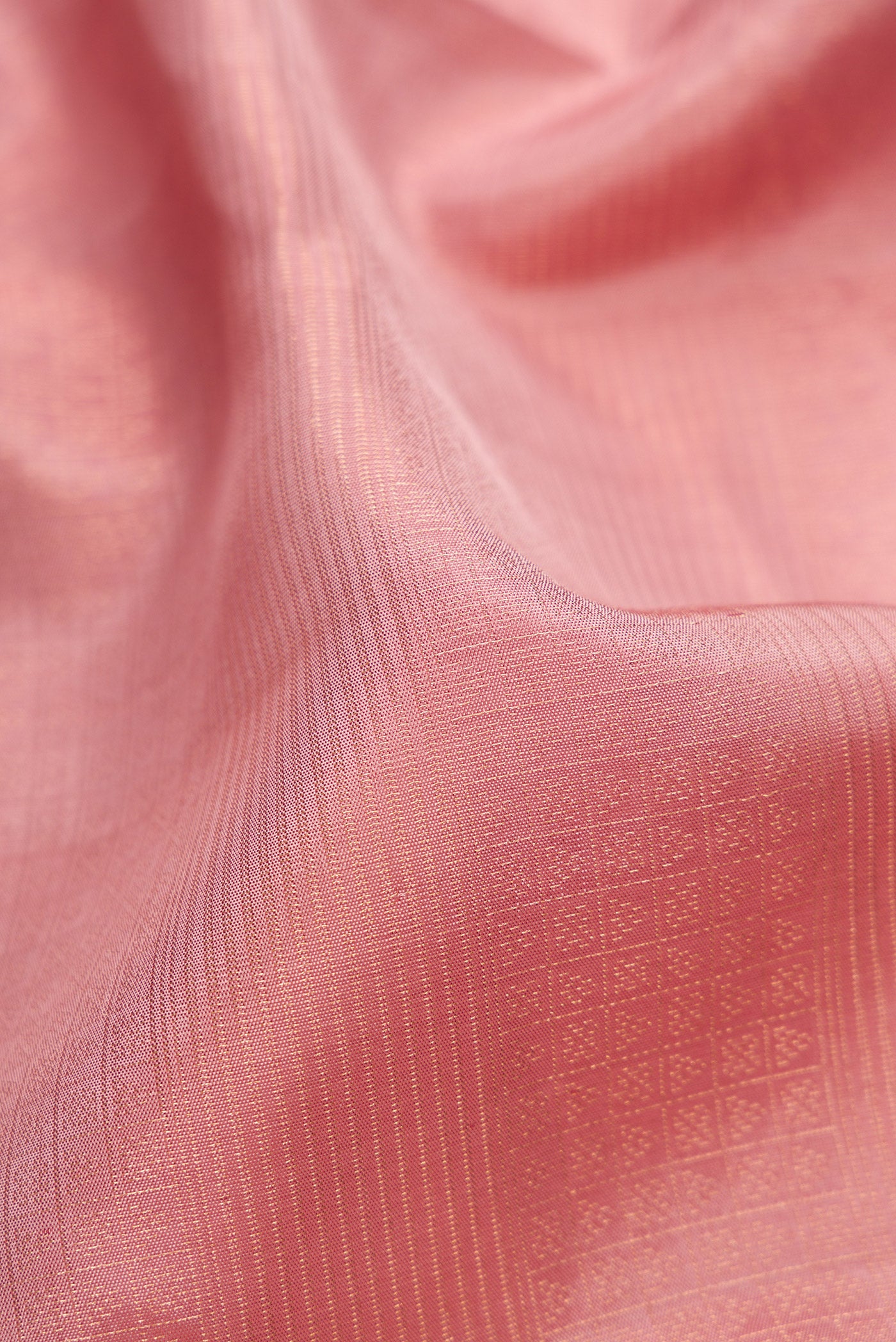 Close up of Rose Gold Soft Silk Saree with Zari Brocade on the body and Fancy Border.  displaying folds