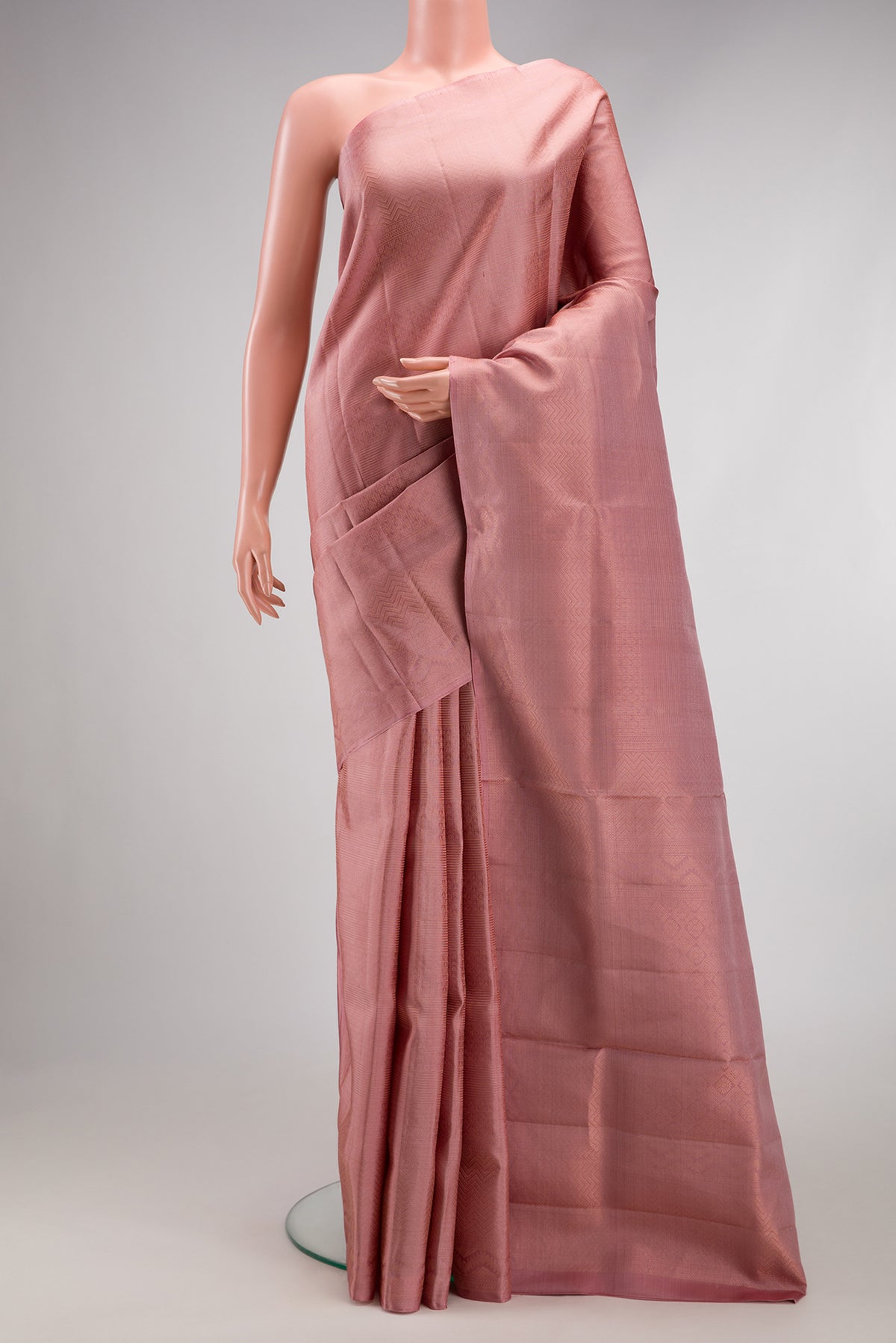 Rose Gold Soft Silk Saree with Zari Brocade on the body and Fancy Border.  displayed on a mannequin