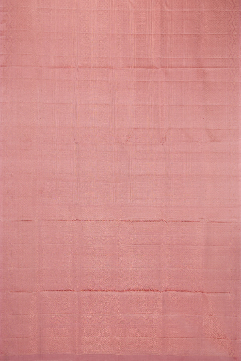 Flat view of Rose Gold Soft Silk Saree with Zari Brocade on the body and Fancy Border. 