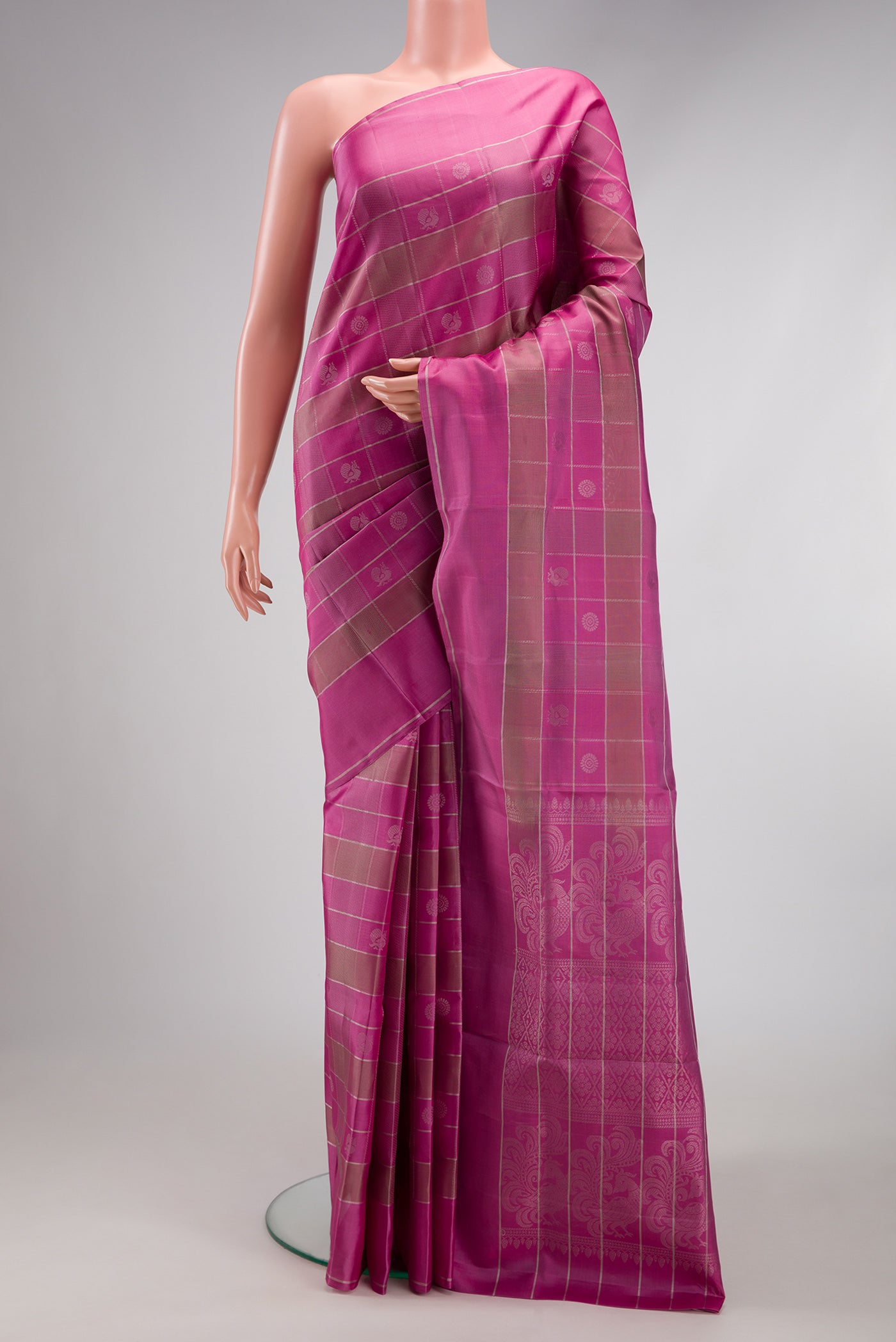 Pink Soft Silk Saree with Checked design on the body and Plain Border.  displayed on a mannequin