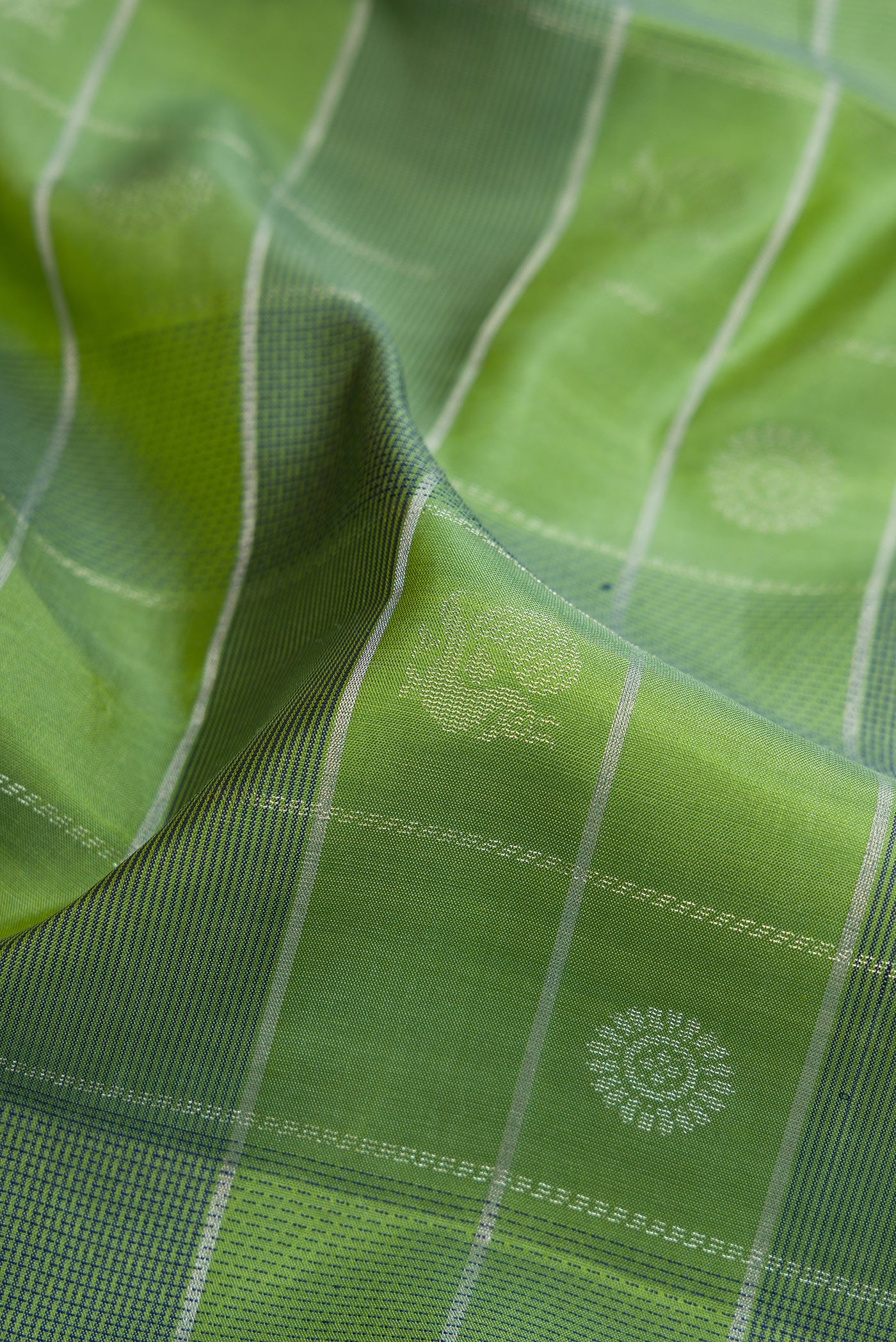 Close up of Green Soft Silk Saree with Checked design on the body and Plain Border.  displaying folds