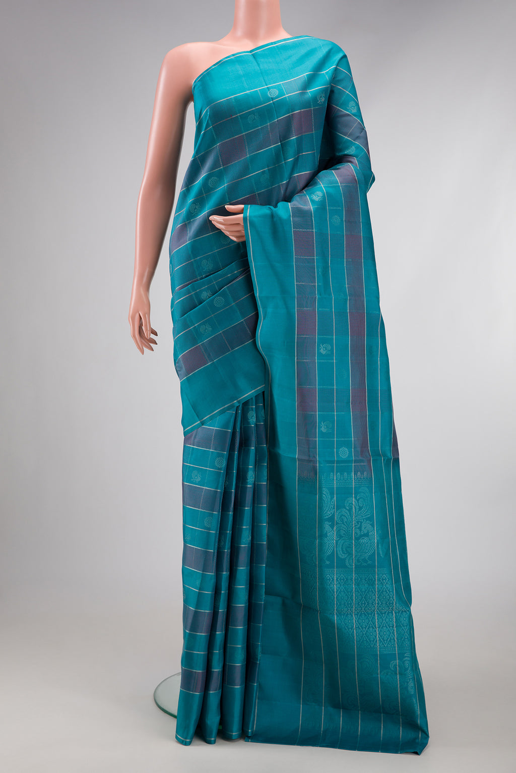 Sky Blue Soft Silk Saree with Checked design on the body and Plain Border.  displayed on a mannequin