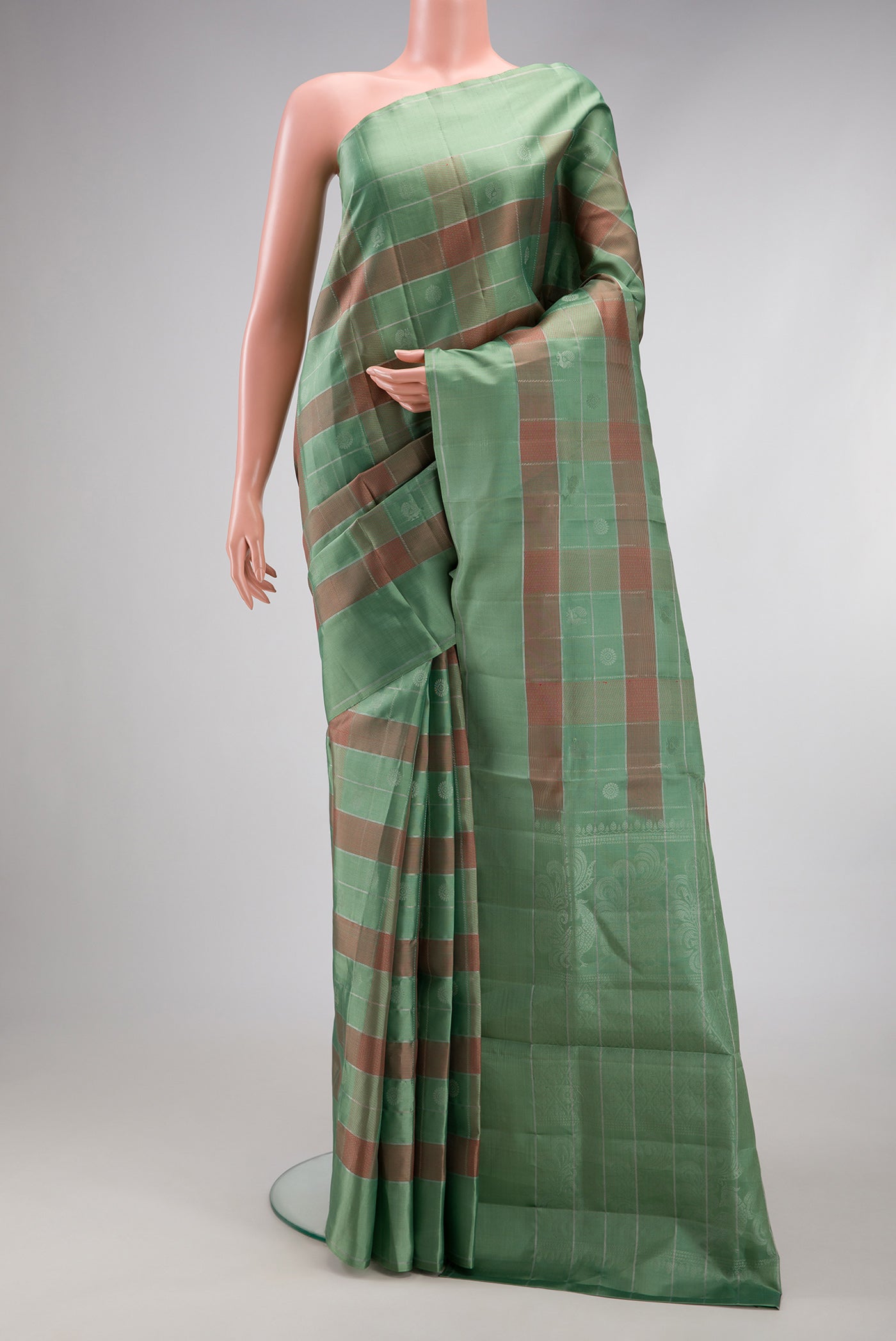 Sage Green Soft Silk Saree with Checked design on the body and Plain Border.  displayed on a mannequin
