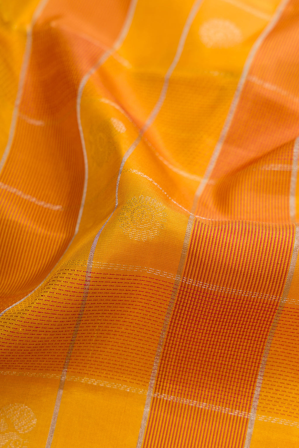 Close up of Mustard Soft Silk Saree with Checked design on the body and Plain Border.  displaying folds