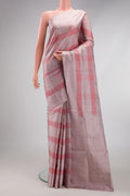 Rose Gold Soft Silk Saree with Checked design on the body and Plain Border.  displayed on a mannequin
