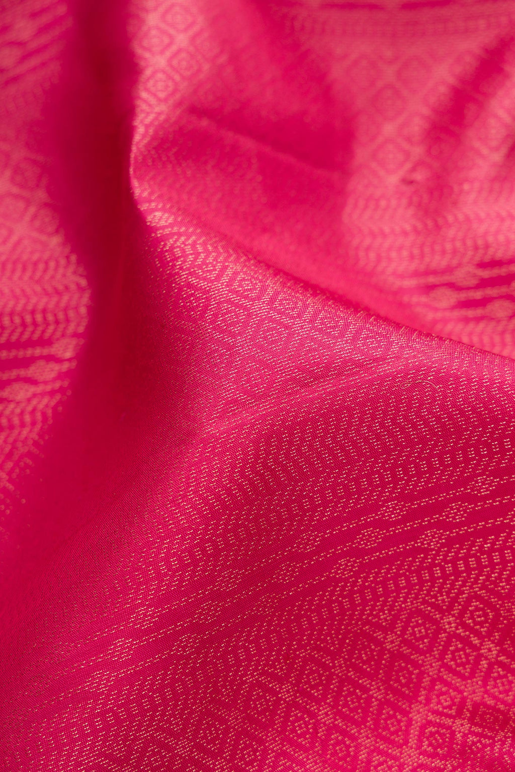 Close up of Pink Soft Silk Saree with Zari Brocade on the body and Fancy Border.  displaying folds