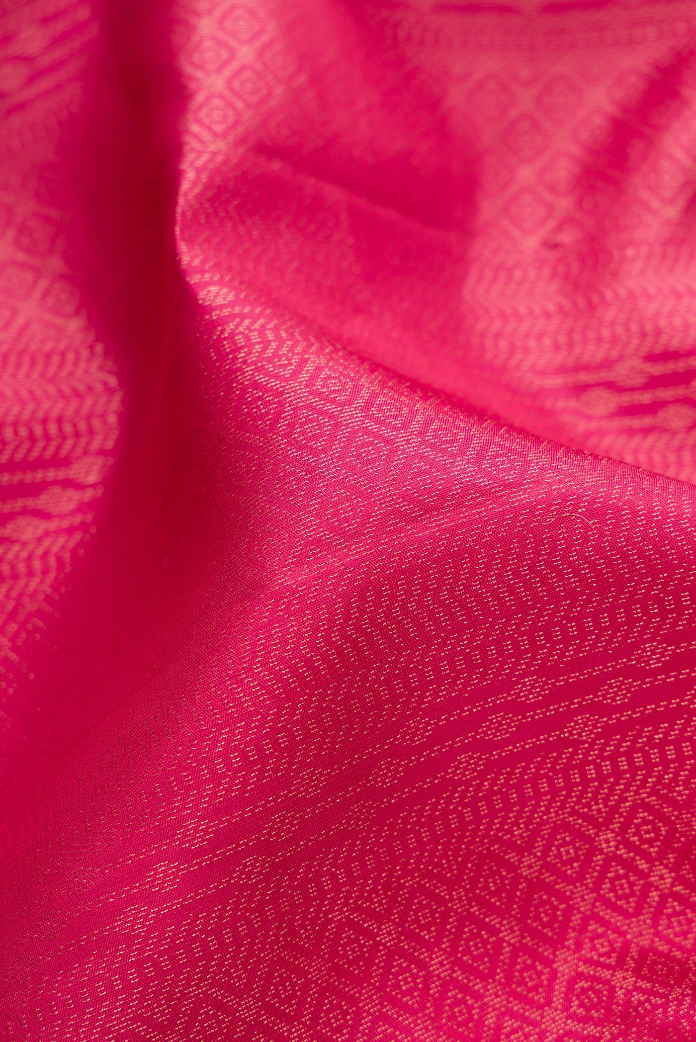 Close up of Pink Soft Silk Saree with Zari Brocade on the body and Fancy Border.  displaying folds