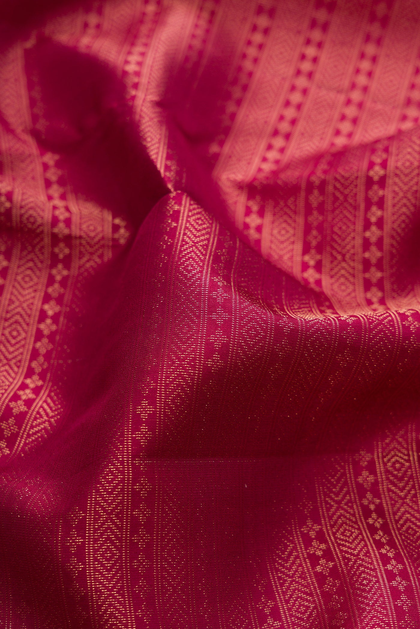 Close up of Maroon Soft Silk Saree with Zari Brocade on the body and Fancy Border.  displaying folds
