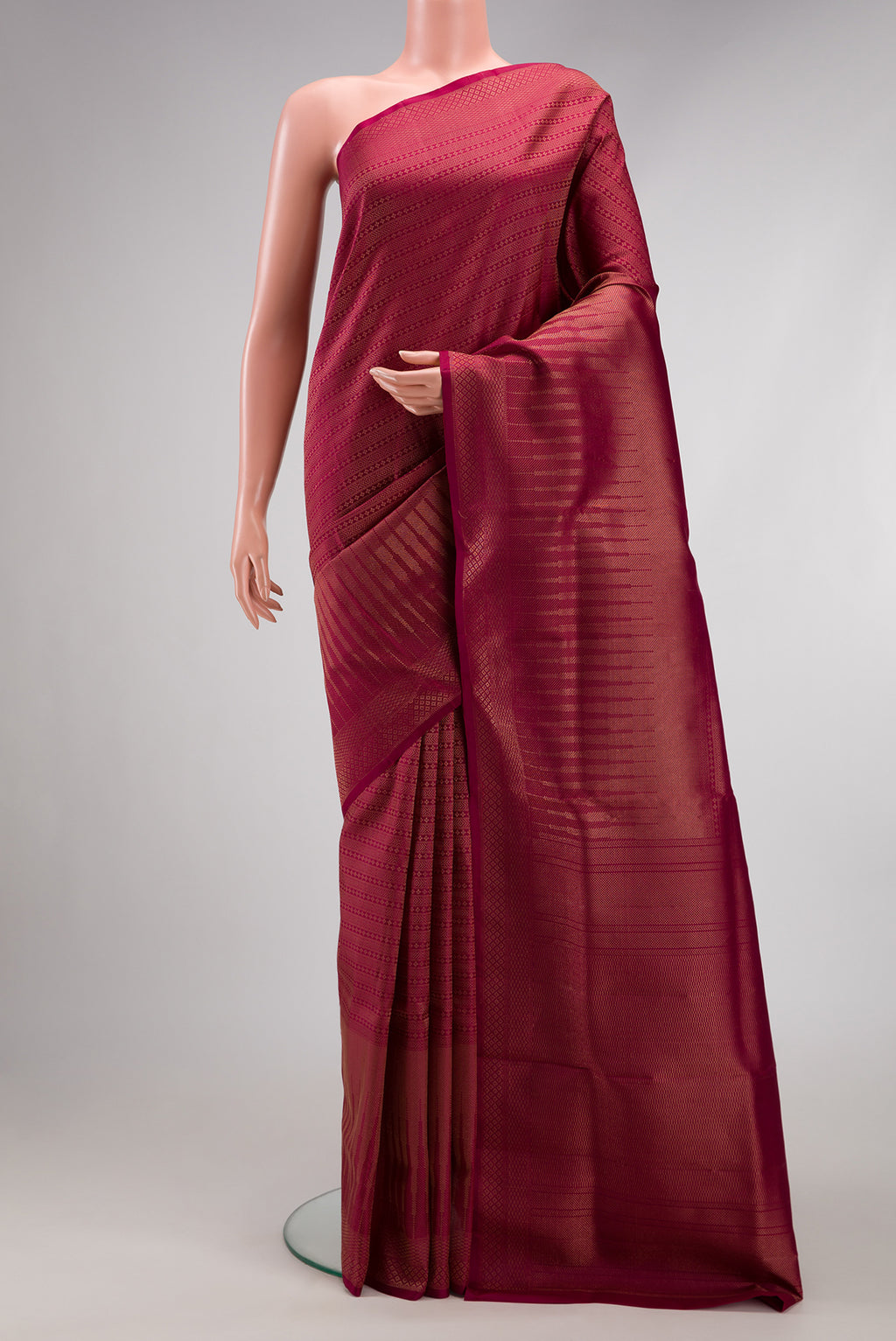 Maroon Soft Silk Saree with Zari Brocade on the body and Fancy Border.  displayed on a mannequin