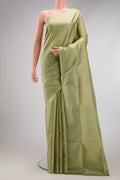 Pista Green Soft Silk Saree with Zari Brocade on the body and Fancy Border.  displayed on a mannequin