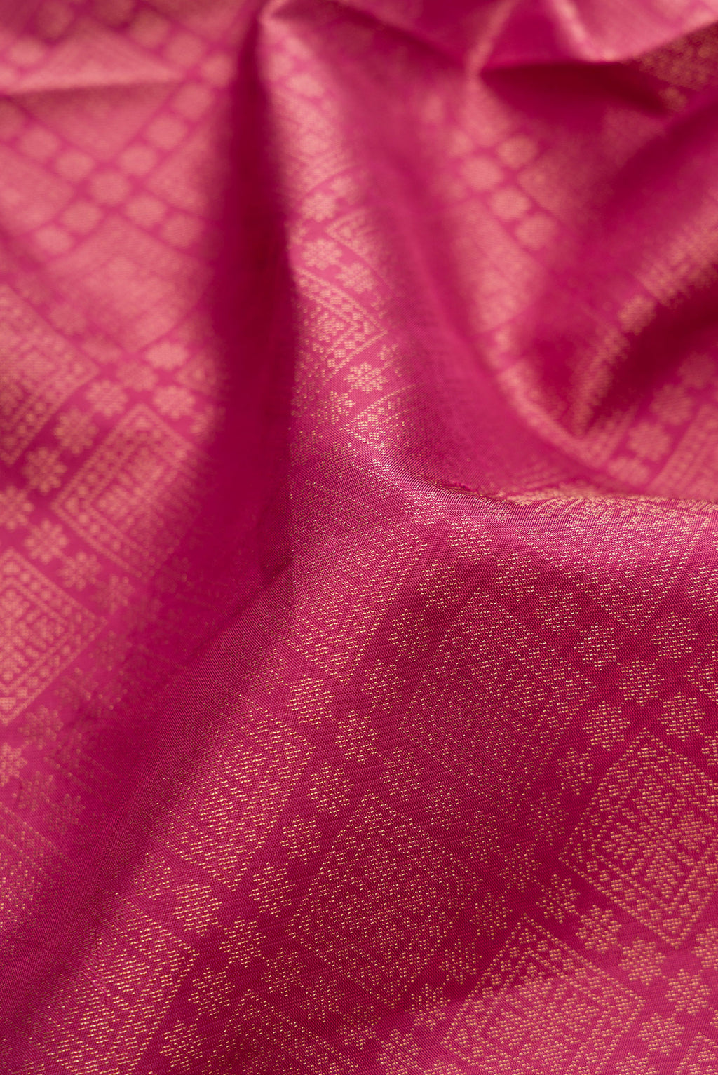 Close up of Pink Soft Silk Saree with Zari Brocade on the body and Fancy Border.  displaying folds