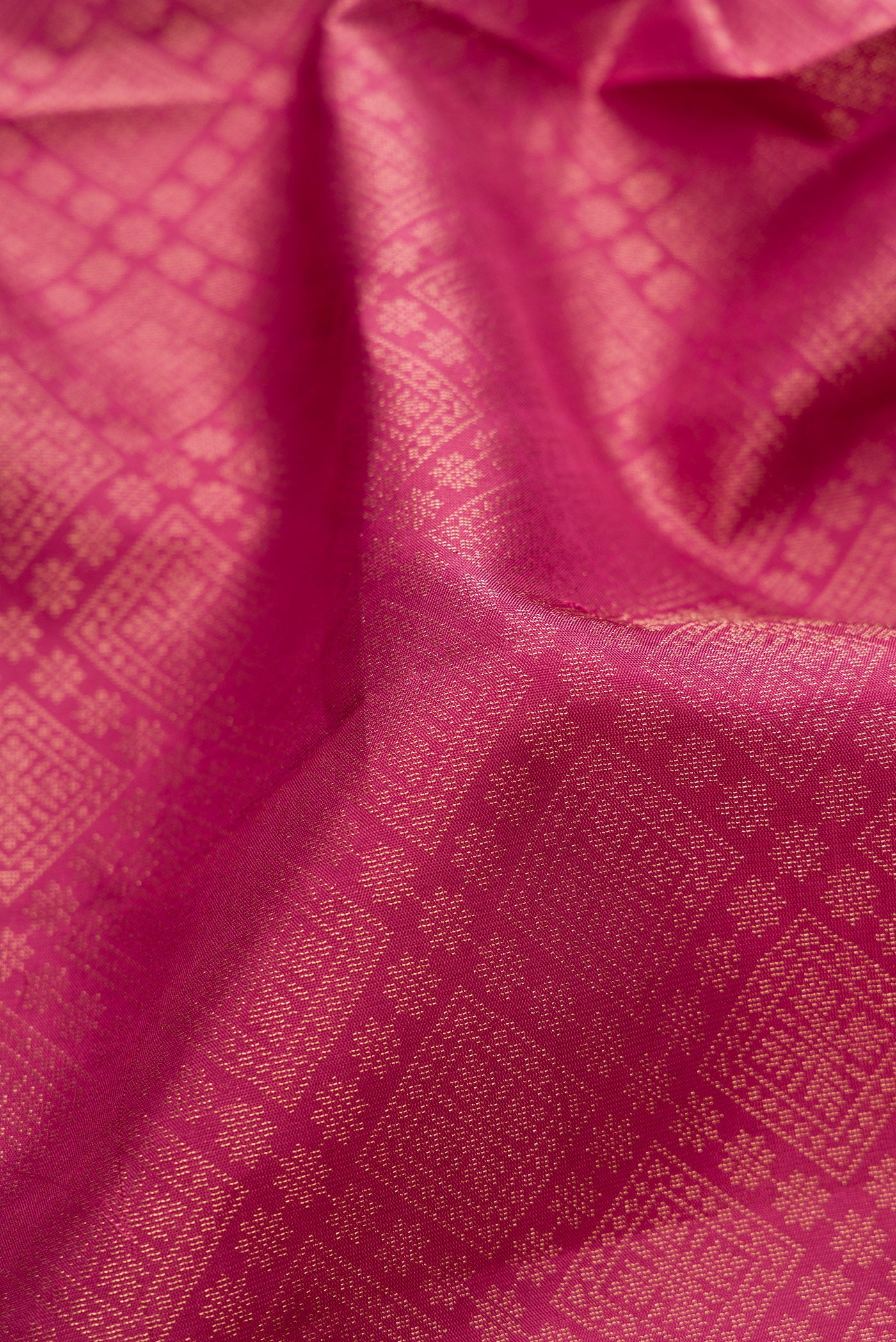 Close up of Pink Soft Silk Saree with Zari Brocade on the body and Fancy Border.  displaying folds
