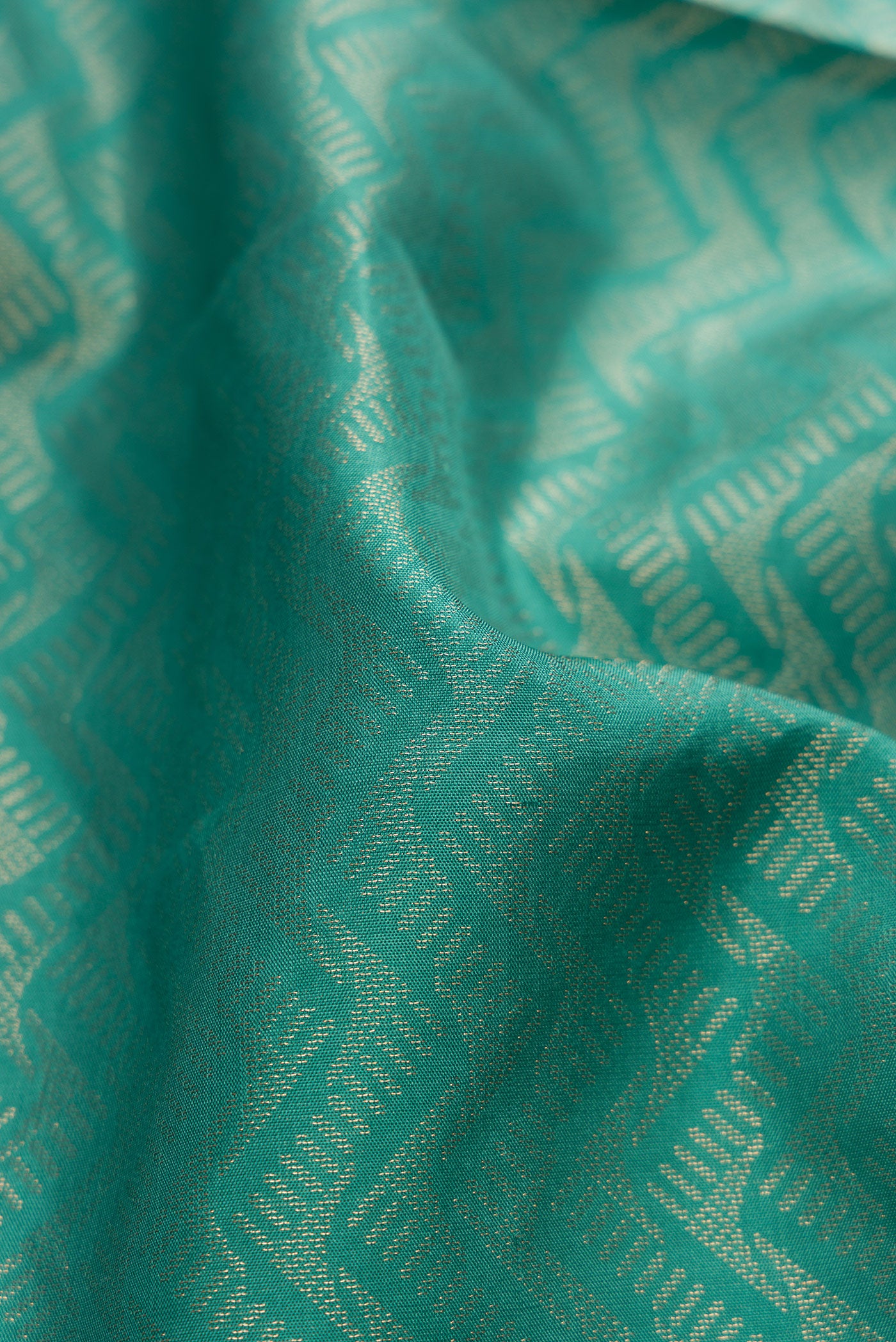 Close up of Maya Blue Soft Silk Saree with Zari Brocade on the body and Fancy Border.  displaying folds