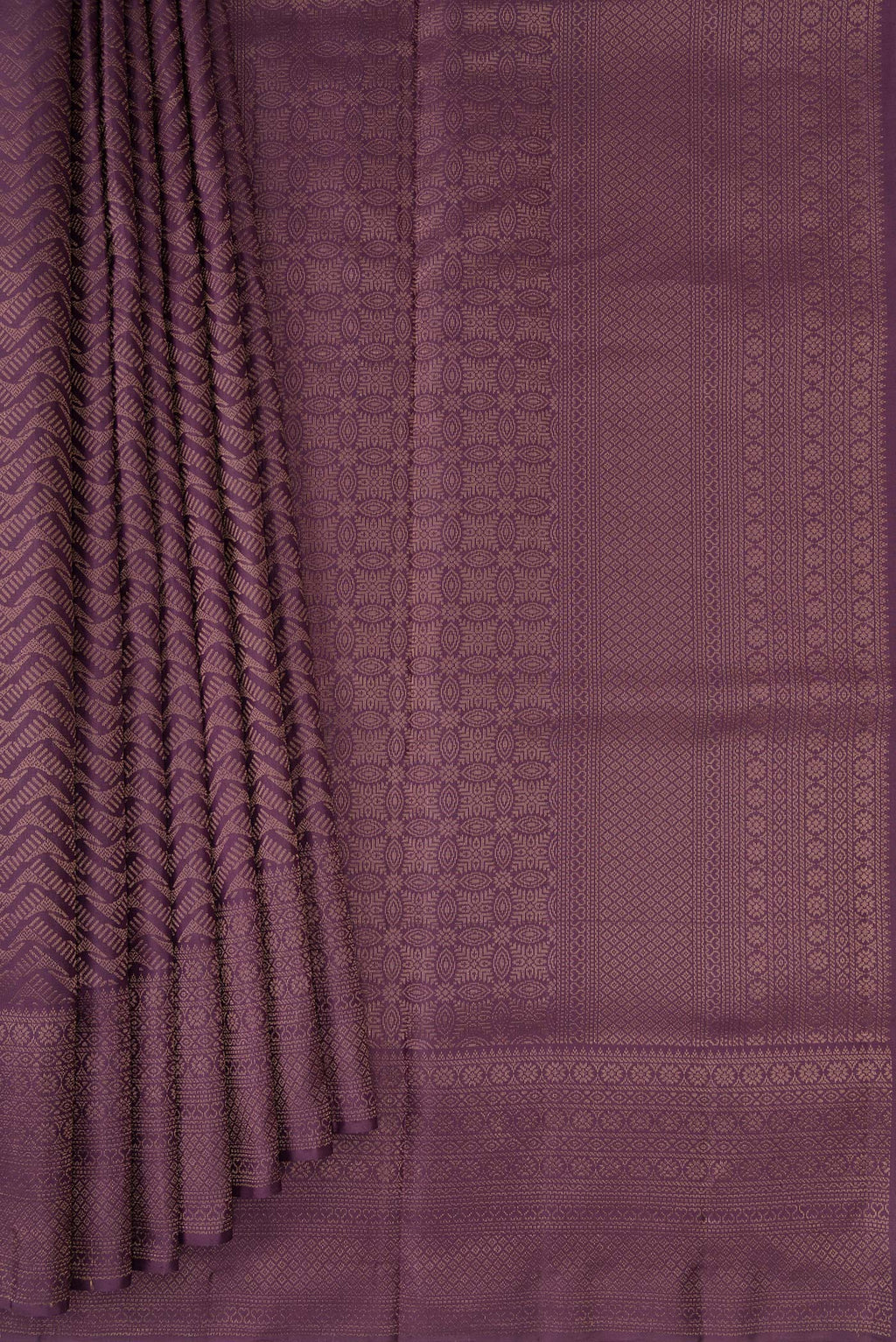 Pleats and pallu of Purple Soft Silk Saree with Zari Brocade on the body and Fancy Border. 