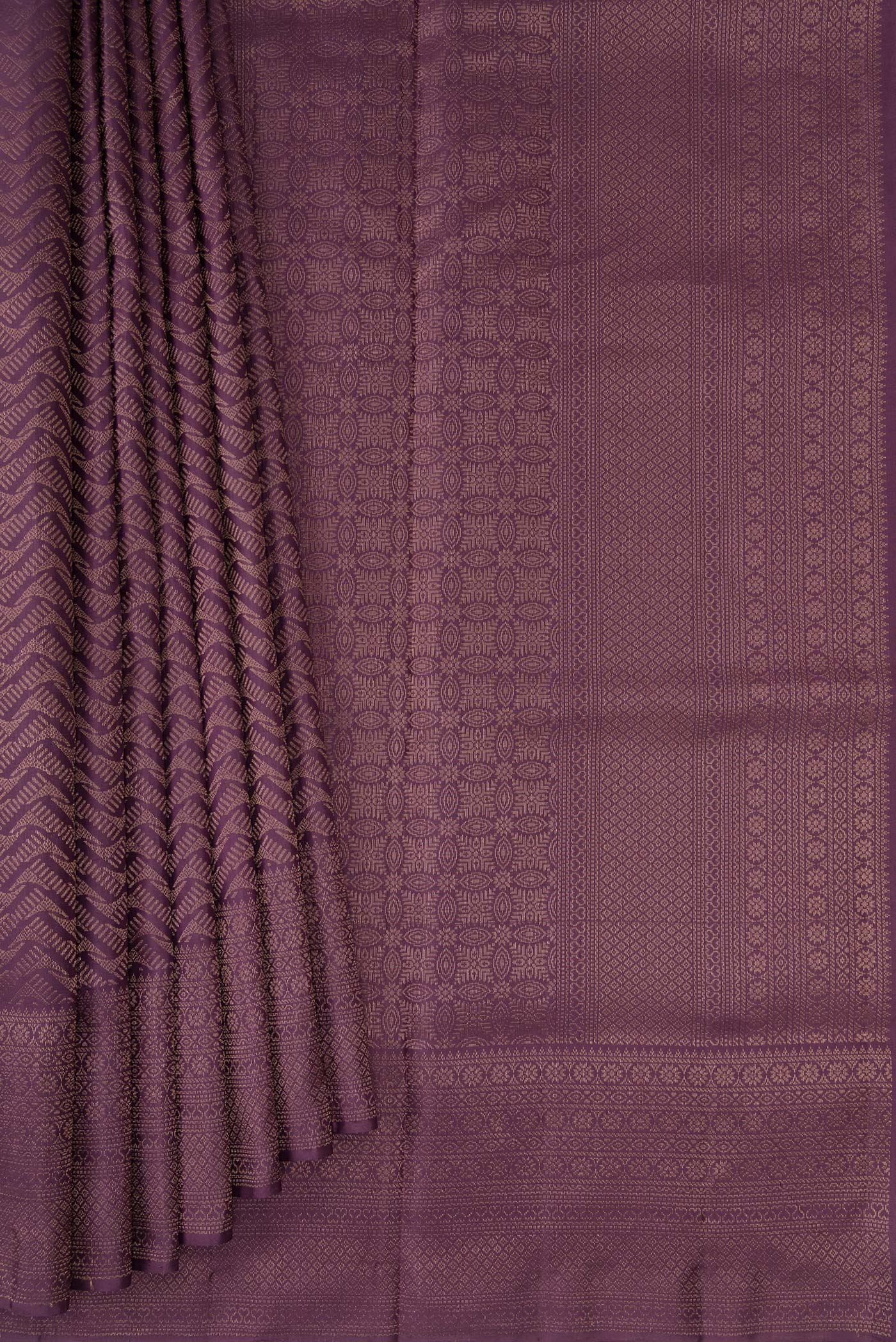 Pleats and pallu of Purple Soft Silk Saree with Zari Brocade on the body and Fancy Border. 