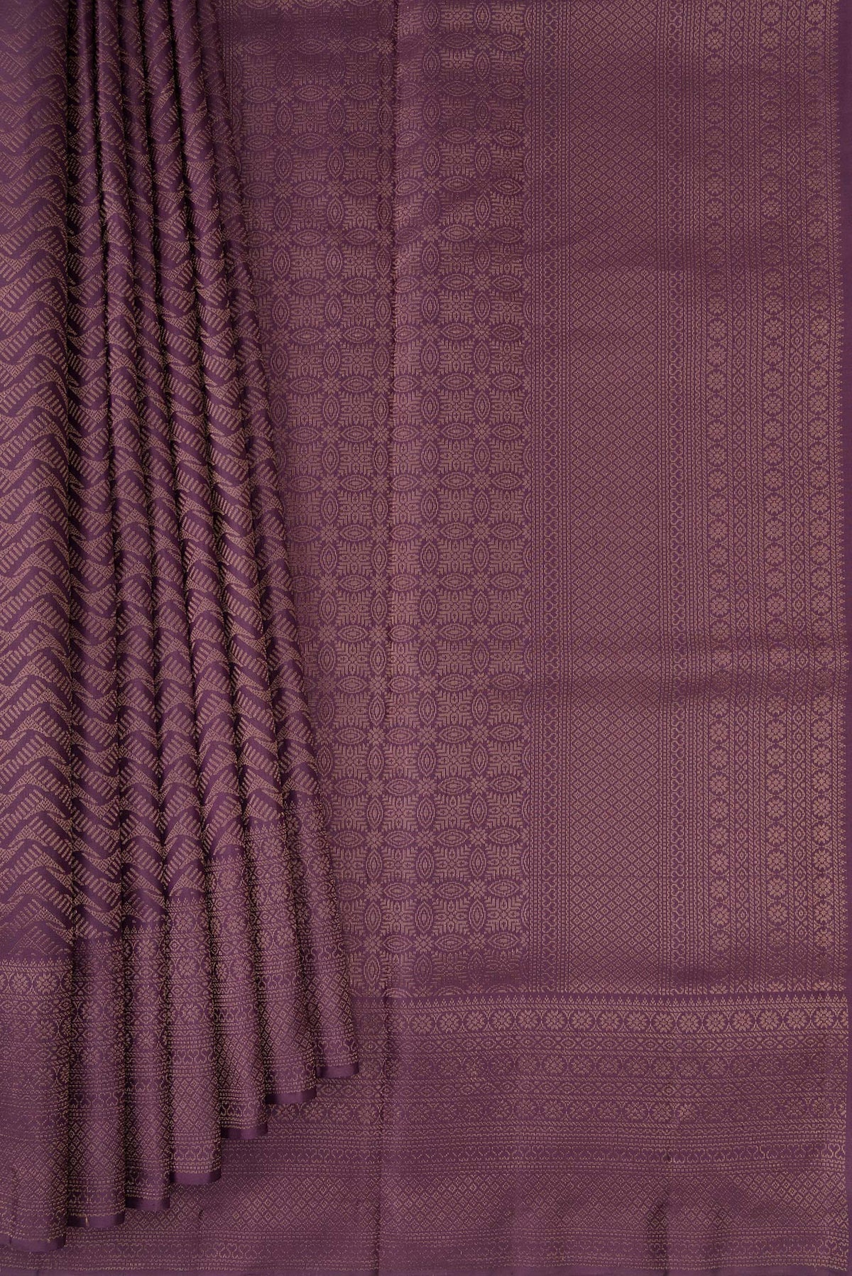 Pleats and pallu of Purple Soft Silk Saree with Zari Brocade on the body and Fancy Border. 