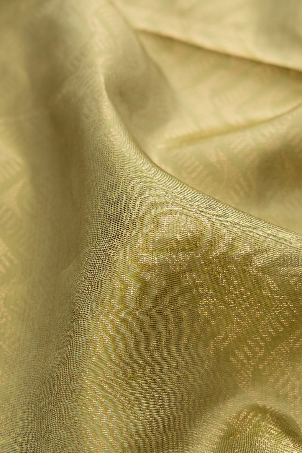 Close up of Sage Green Soft Silk Saree with Zari Brocade on the body and Fancy Border.  displaying folds