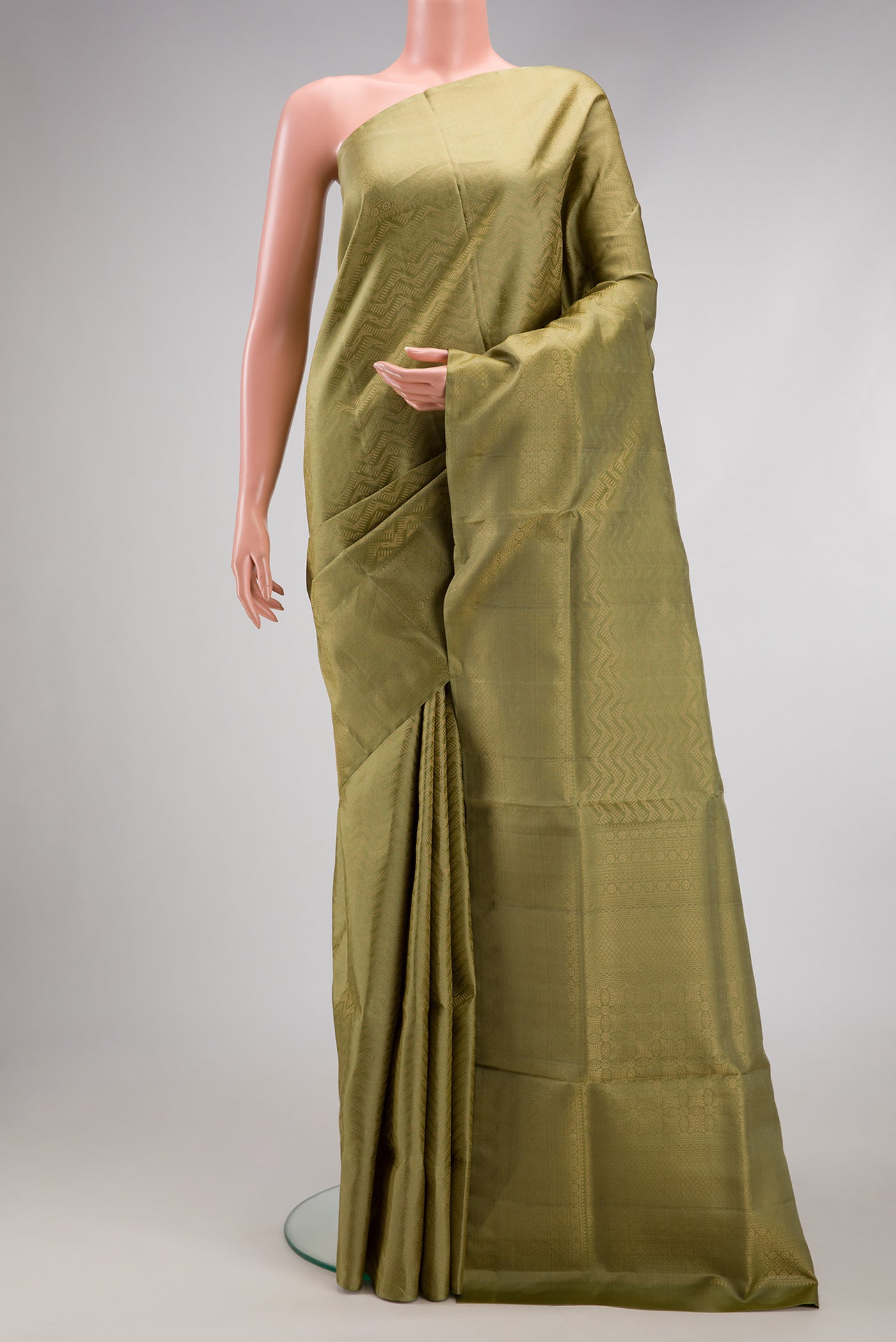 Sage Green Soft Silk Saree with Zari Brocade on the body and Fancy Border.  displayed on a mannequin