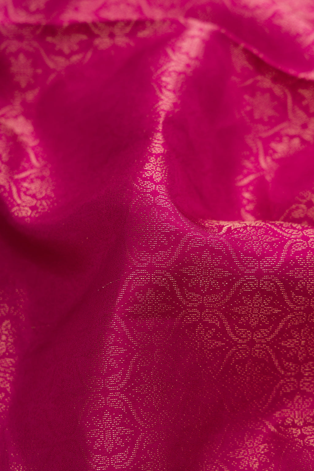 Close up of Magenta Soft Silk Saree with Zari Brocade on the body and Fancy Border.  displaying folds