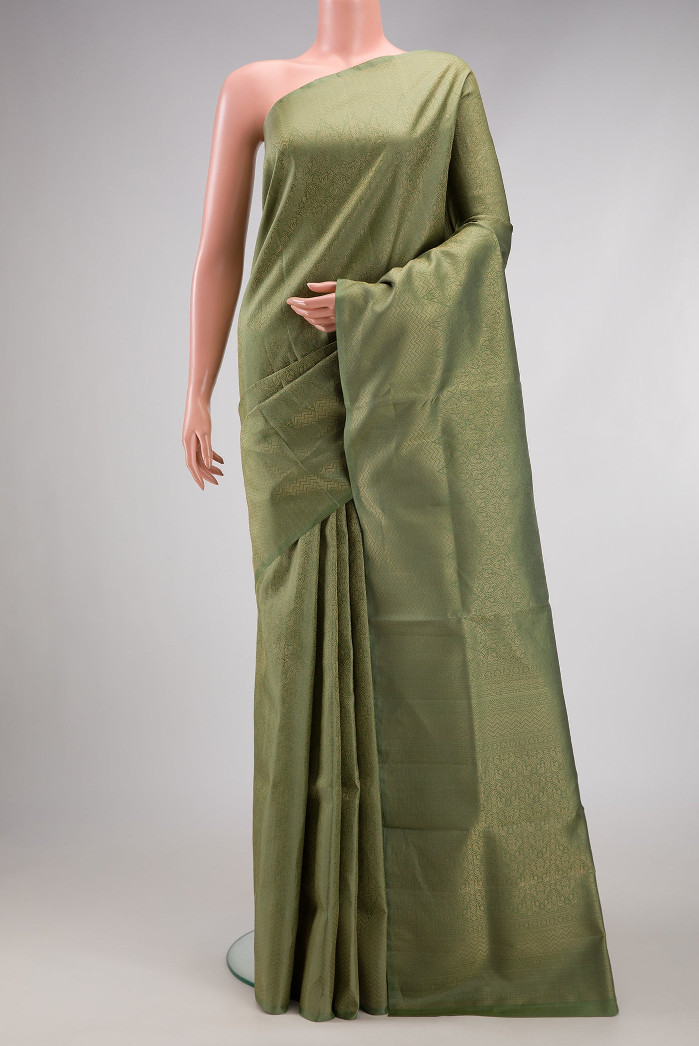 Sage Green Soft Silk Saree with Zari Brocade on the body and Fancy Border.  displayed on a mannequin