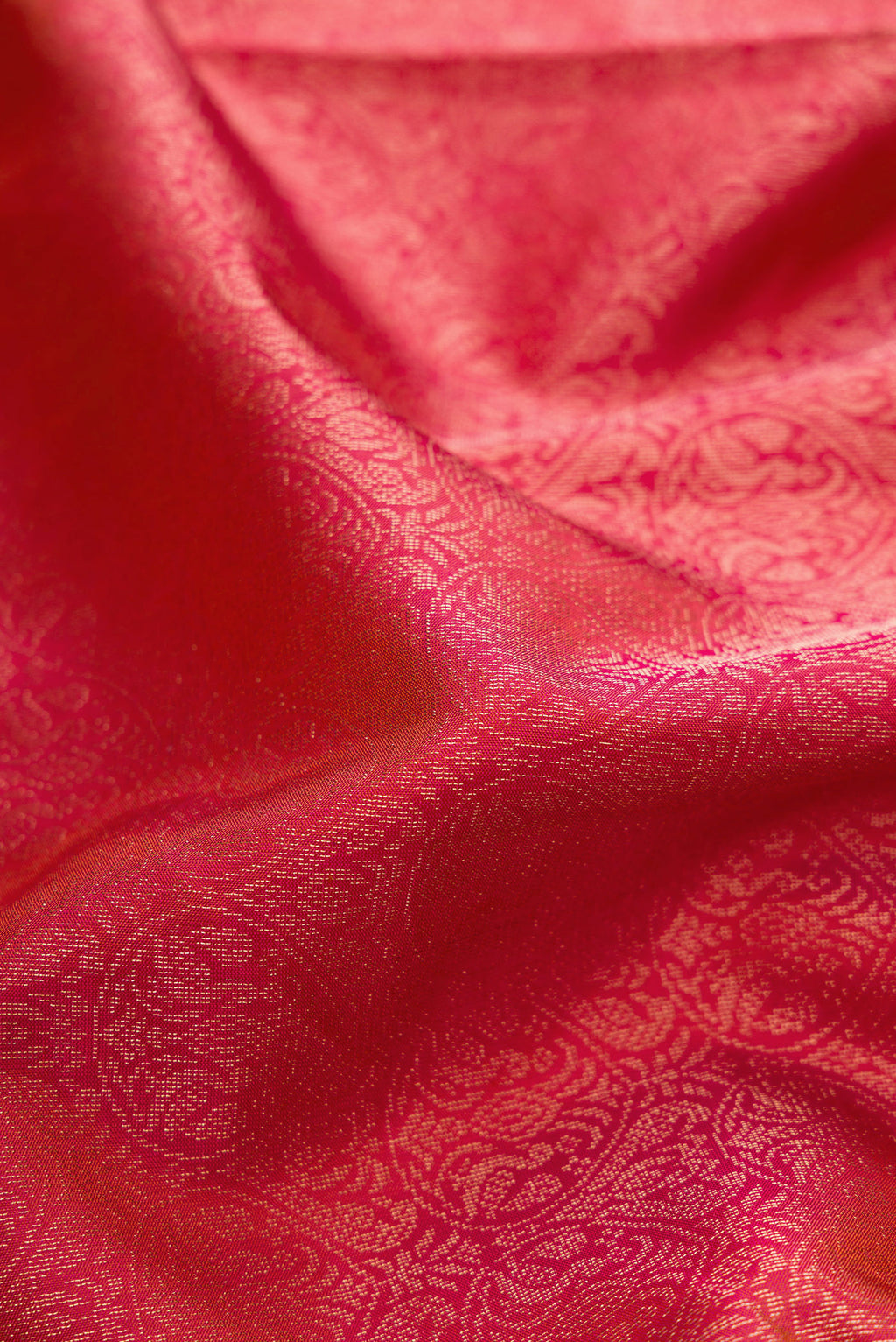 Close up of Coral Soft Silk Saree with Zari Brocade on the body and Fancy Border.  displaying folds