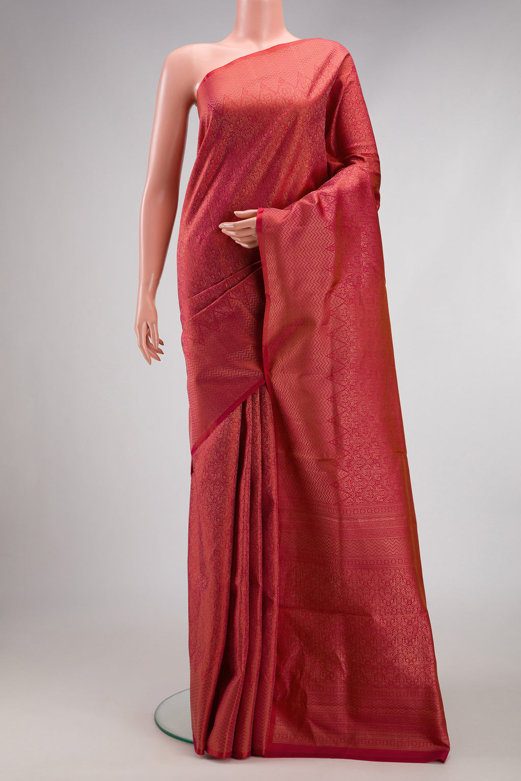 Coral Soft Silk Saree with Zari Brocade on the body and Fancy Border.  displayed on a mannequin