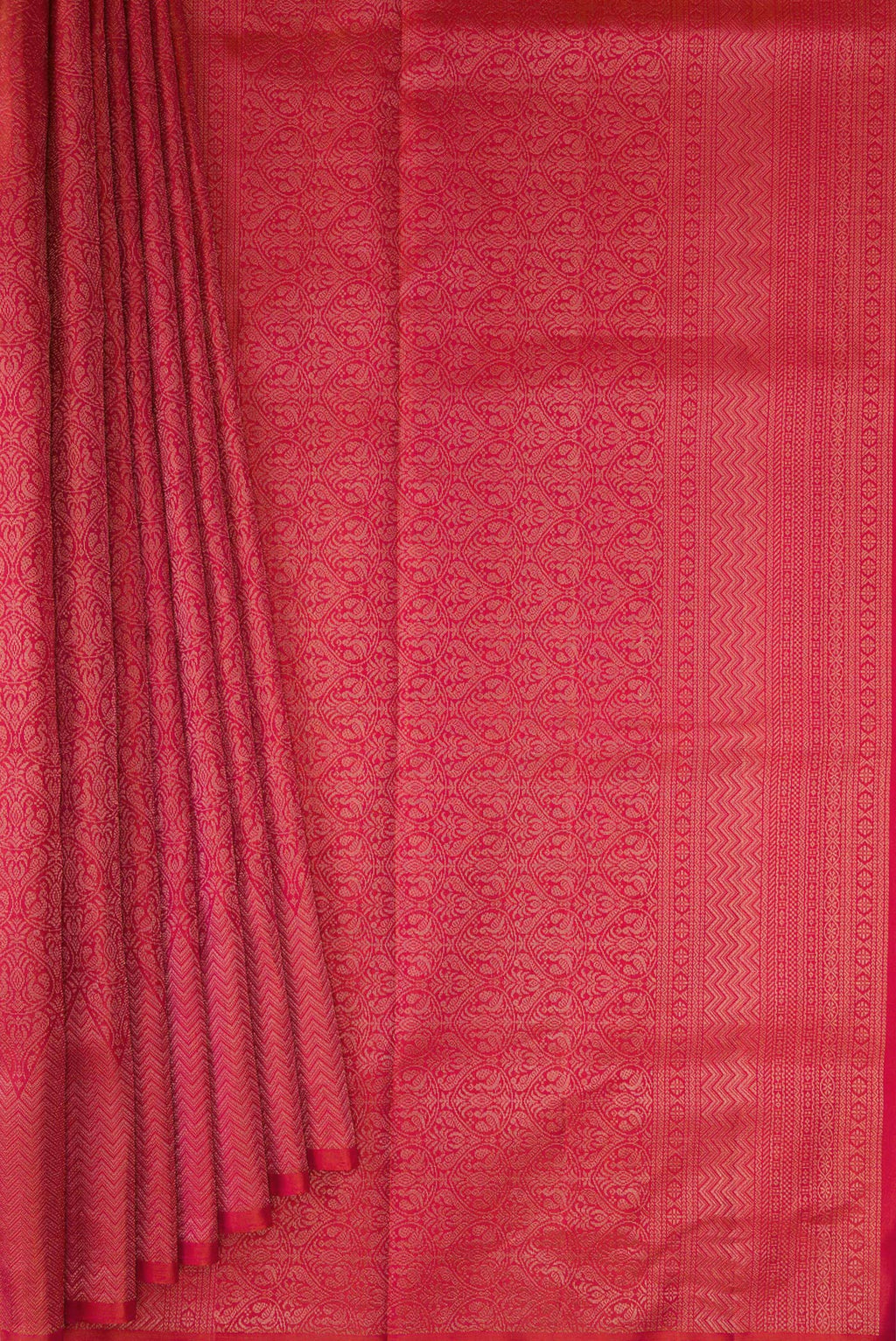Pleats and pallu of Coral Soft Silk Saree with Zari Brocade on the body and Fancy Border. 