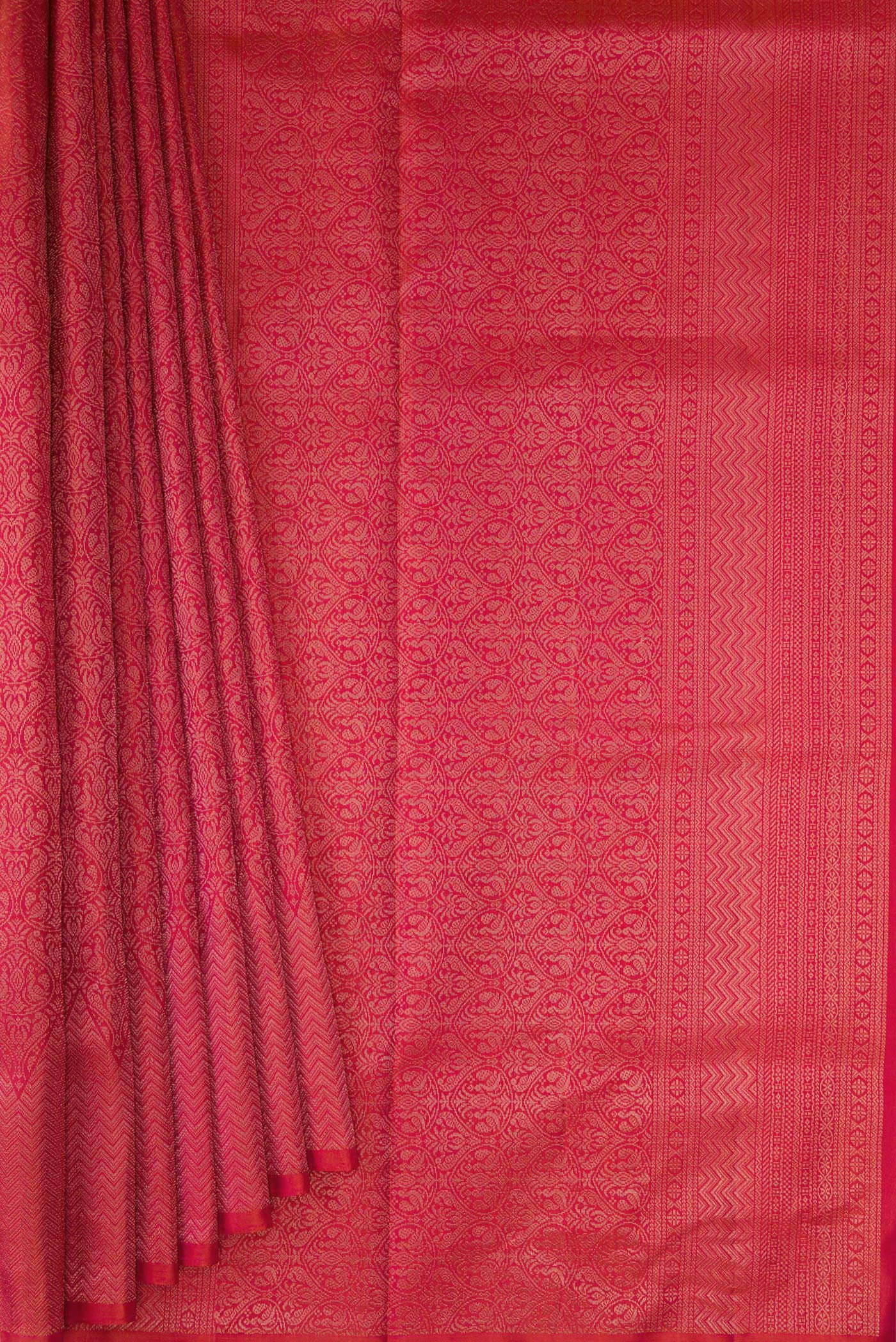 Pleats and pallu of Coral Soft Silk Saree with Zari Brocade on the body and Fancy Border. 