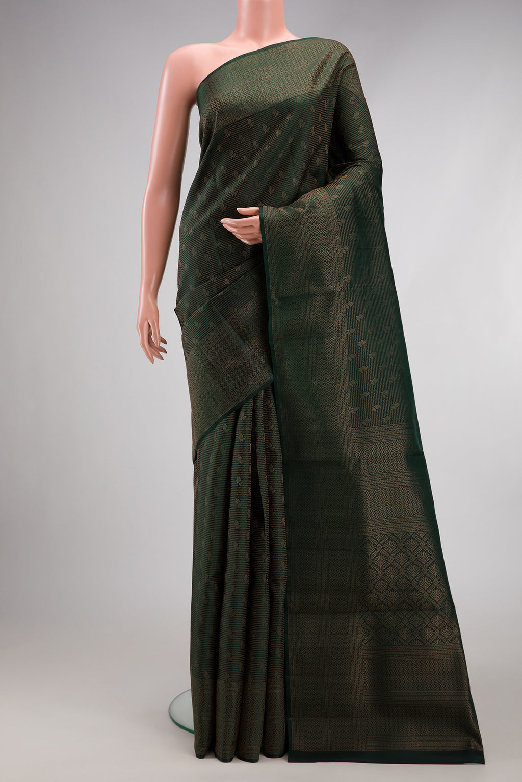 Bottle Green Soft Silk Saree with Zari Brocade on the body and Fancy Border.  displayed on a mannequin