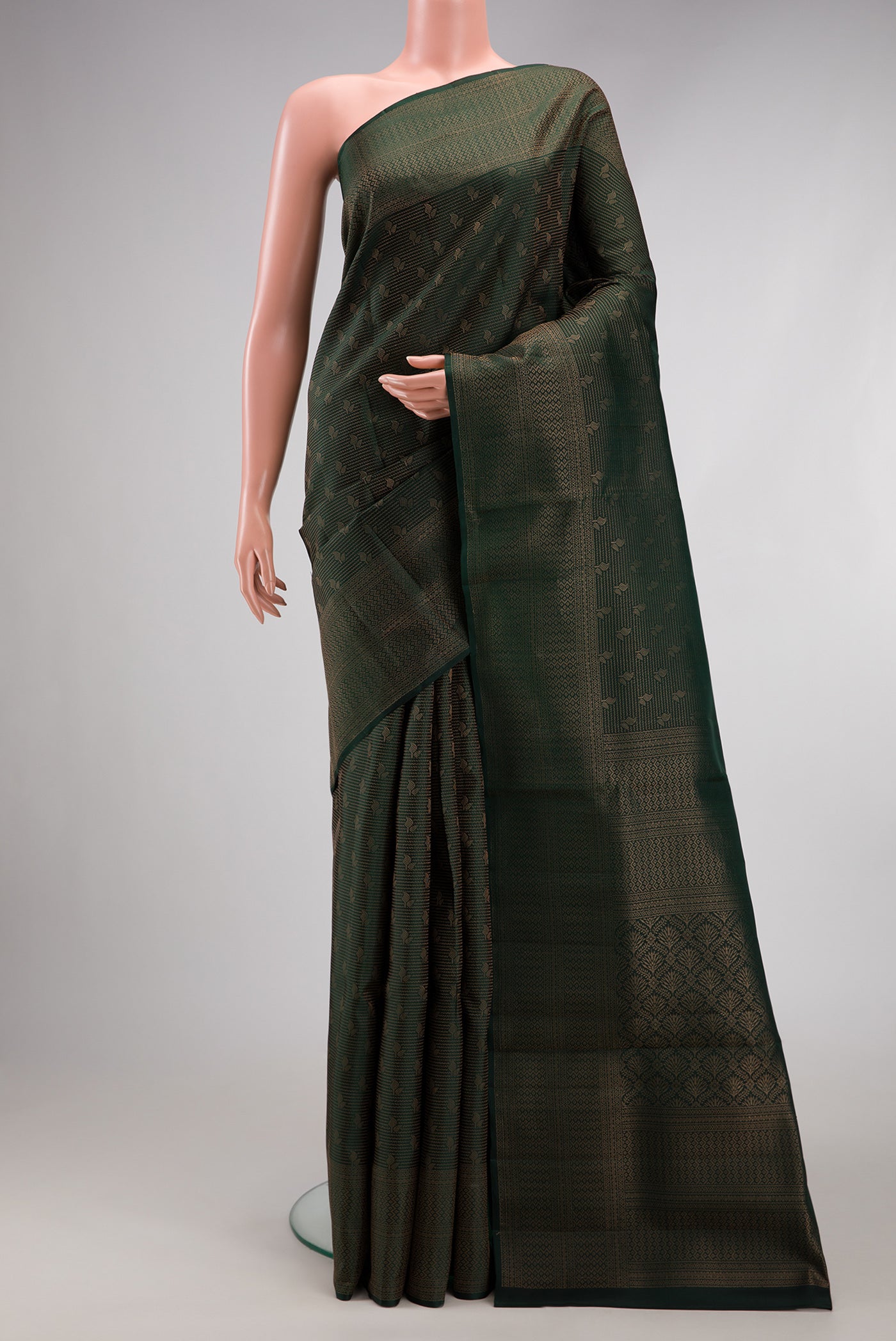 Bottle Green Soft Silk Saree with Zari Brocade on the body and Fancy Border.  displayed on a mannequin
