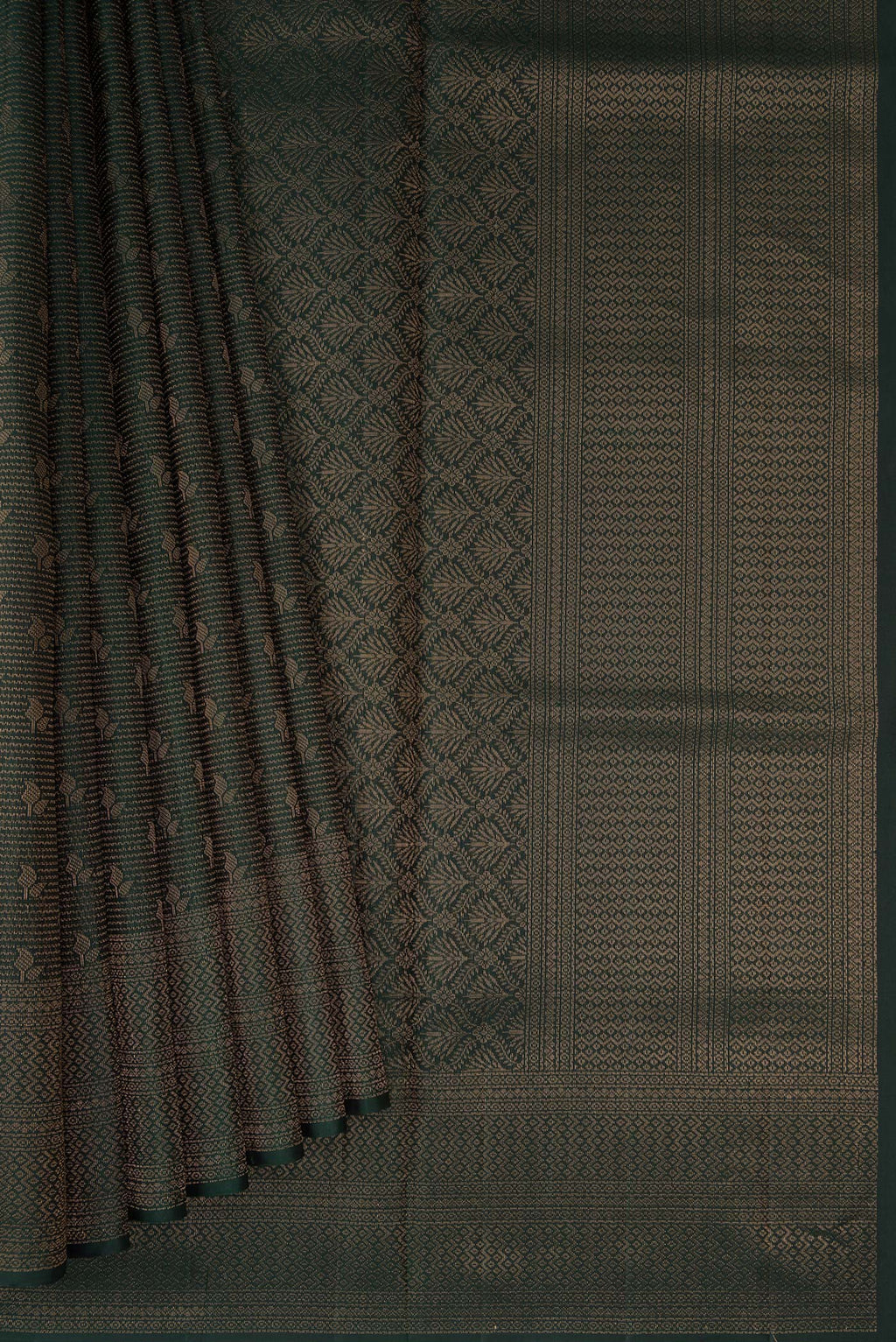 Pleats and pallu of Bottle Green Soft Silk Saree with Zari Brocade on the body and Fancy Border. 