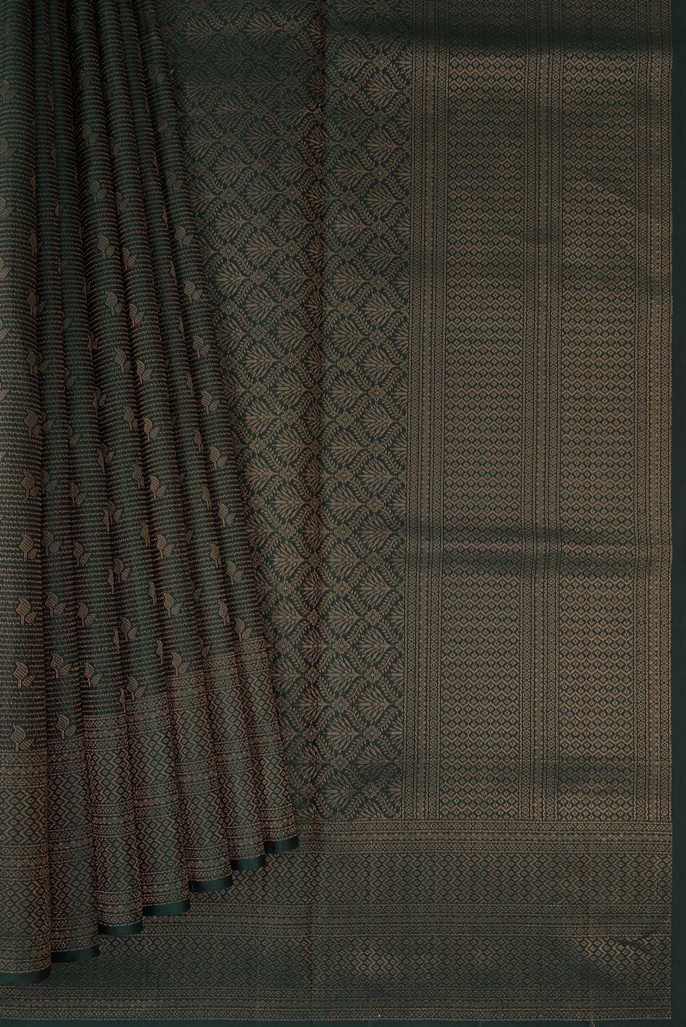 Pleats and pallu of Bottle Green Soft Silk Saree with Zari Brocade on the body and Fancy Border. 
