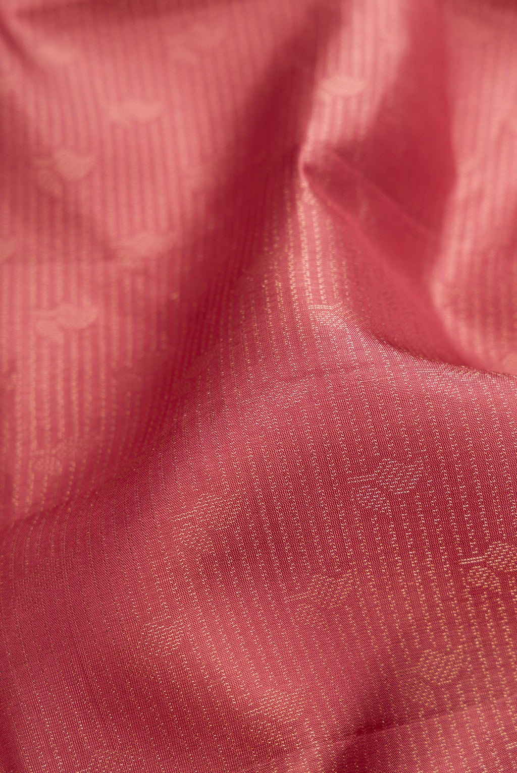 Close up of Rose Gold Soft Silk Saree with Zari Brocade on the body and Fancy Border.  displaying folds
