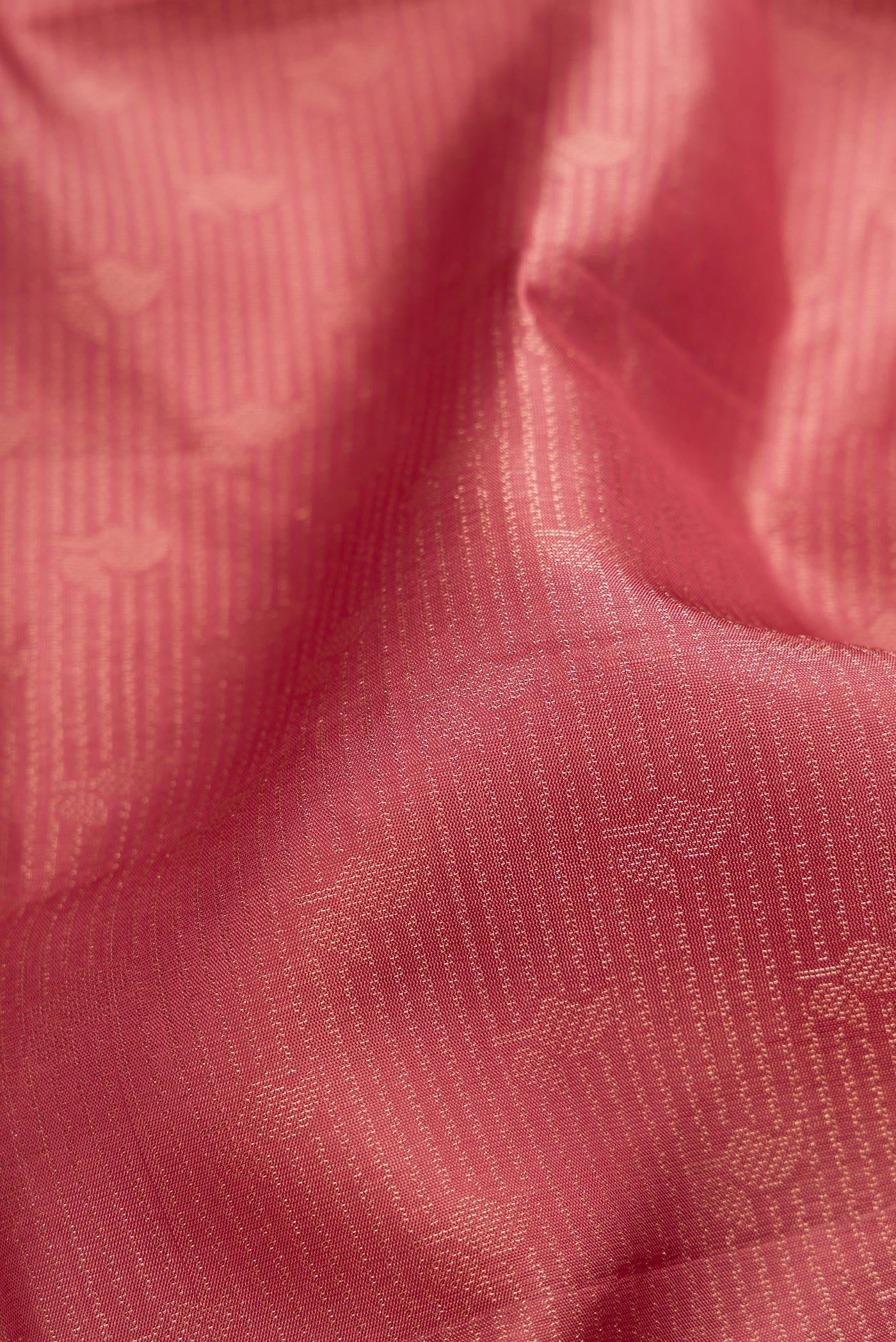 Close up of Rose Gold Soft Silk Saree with Zari Brocade on the body and Fancy Border.  displaying folds