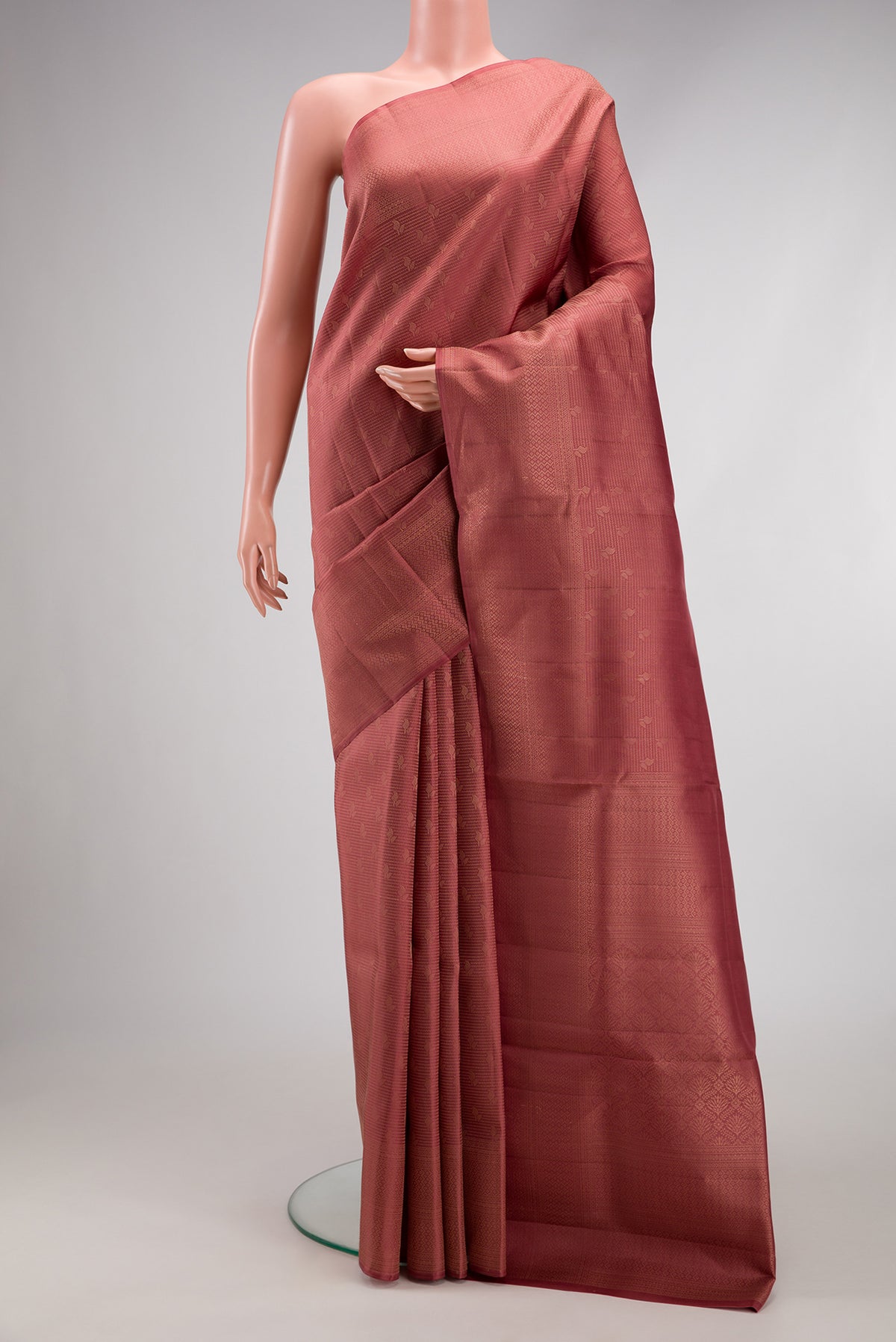 Rose Gold Soft Silk Saree with Zari Brocade on the body and Fancy Border.  displayed on a mannequin