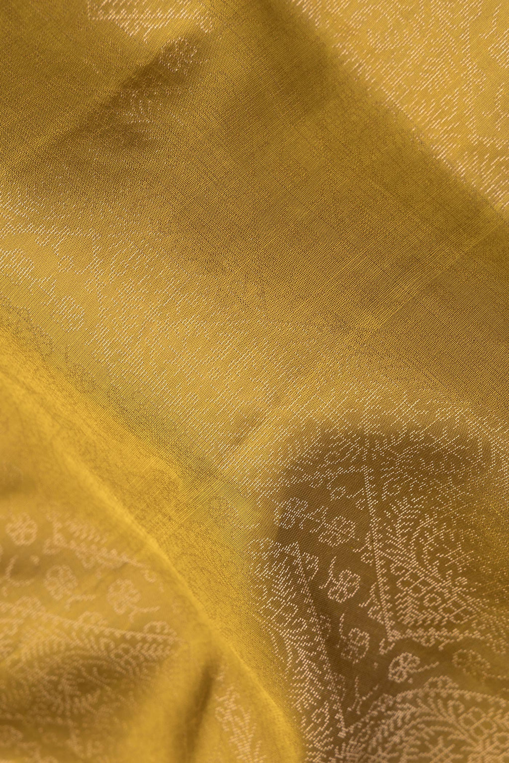 Close up of Pure Silk Mehandi Green Dual Tone Soft Saree with Zari Brocade on the body and Fancy Border.  displaying folds