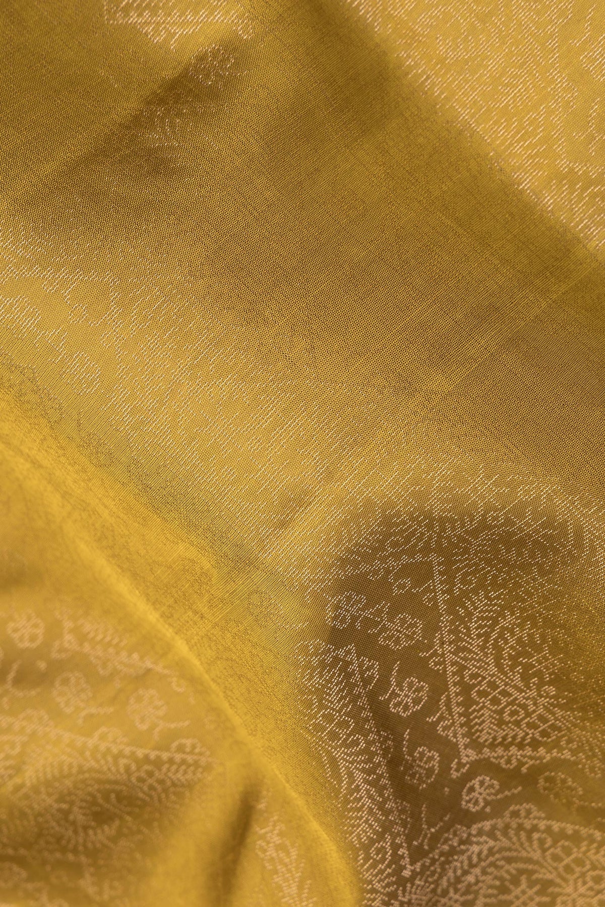 Close up of Pure Silk Mehandi Green Dual Tone Soft Saree with Zari Brocade on the body and Fancy Border.  displaying folds