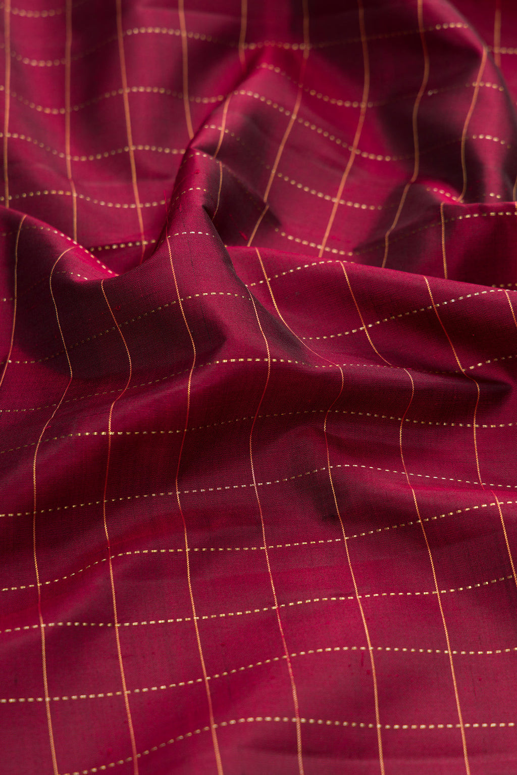 Close up of Maroon Kanjivaram Silk Saree with Checked design on the body and Zari Border.  displaying folds