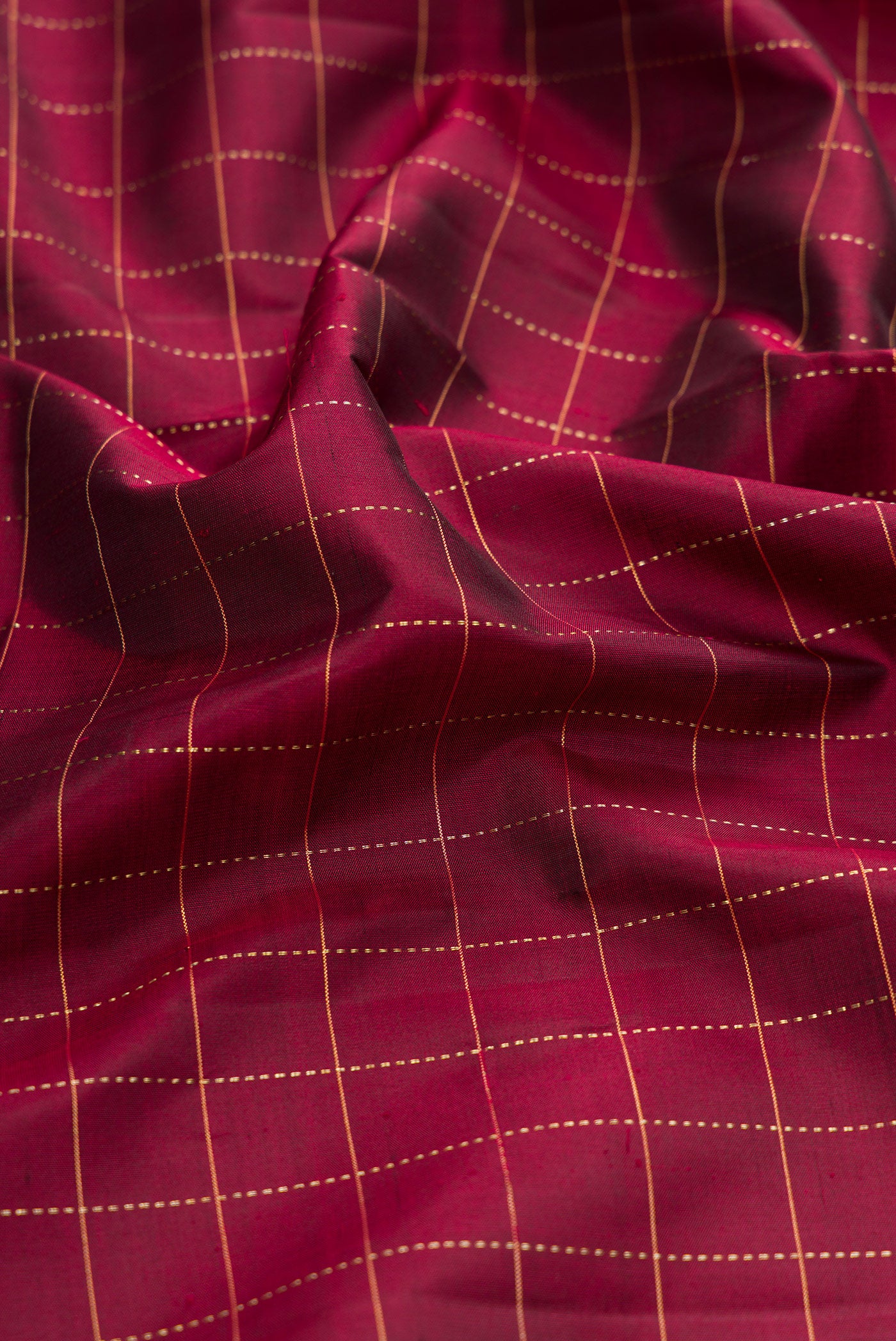 Close up of Maroon Kanjivaram Silk Saree with Checked design on the body and Zari Border.  displaying folds