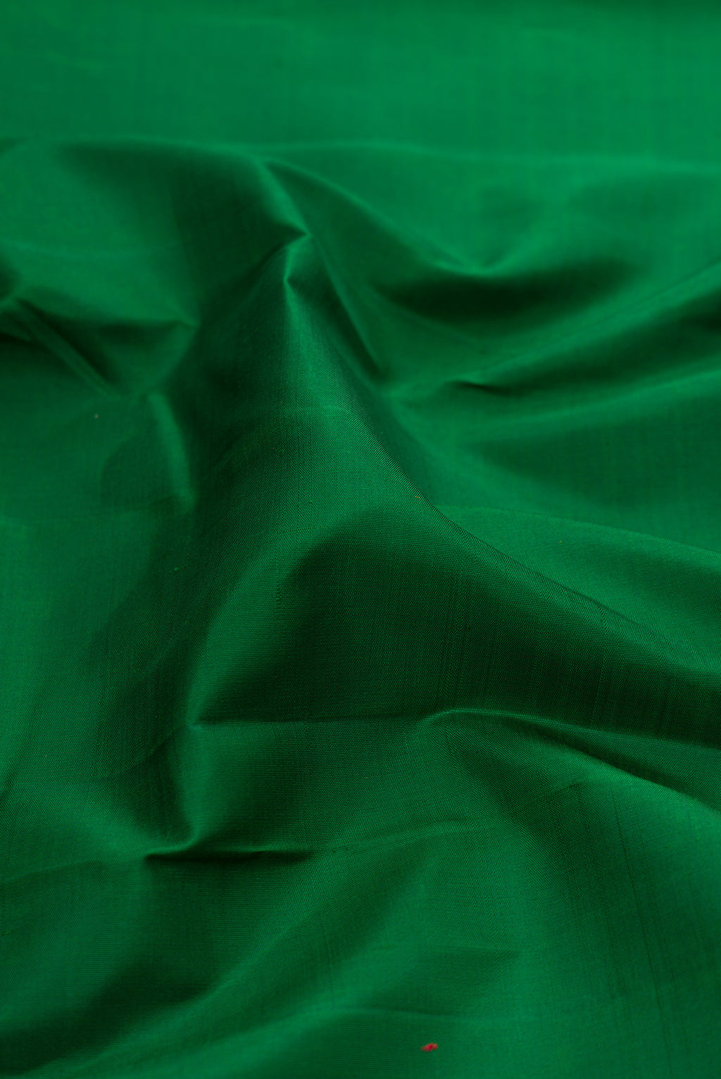 Close up of Bottle Green Kanjivaram Silk Saree with Plain Body and Temple Border.  displaying folds
