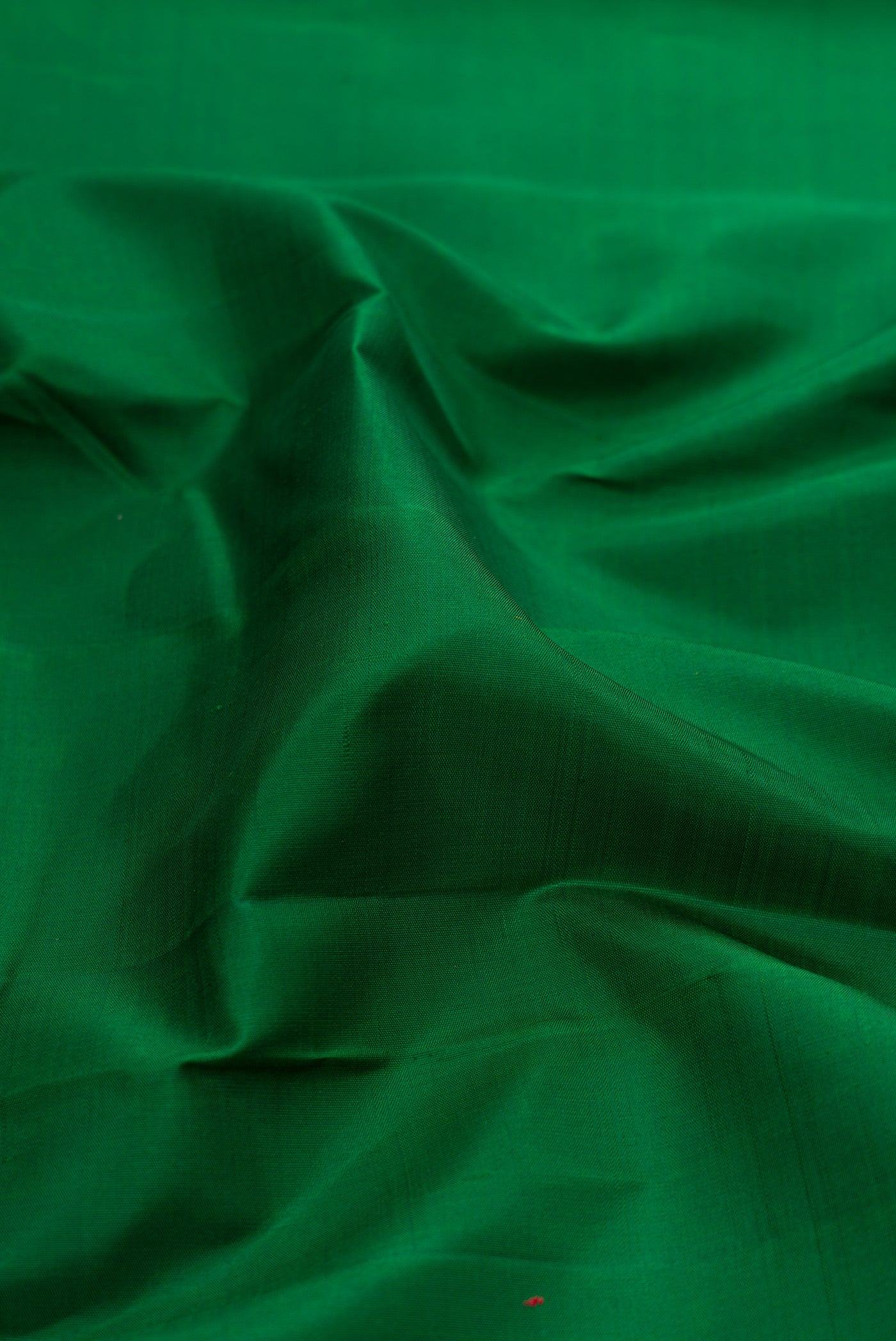 Close up of Bottle Green Kanjivaram Silk Saree with Plain Body and Temple Border.  displaying folds