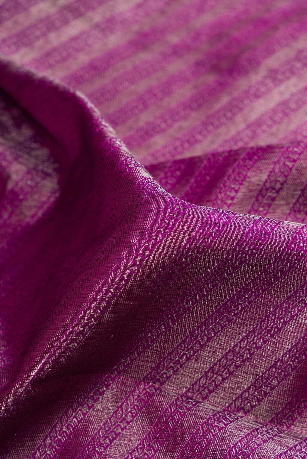 Close up of Pure Silk Magenta Kanjivaram Saree with Zari Brocade on the body and Zari Border.  displaying folds